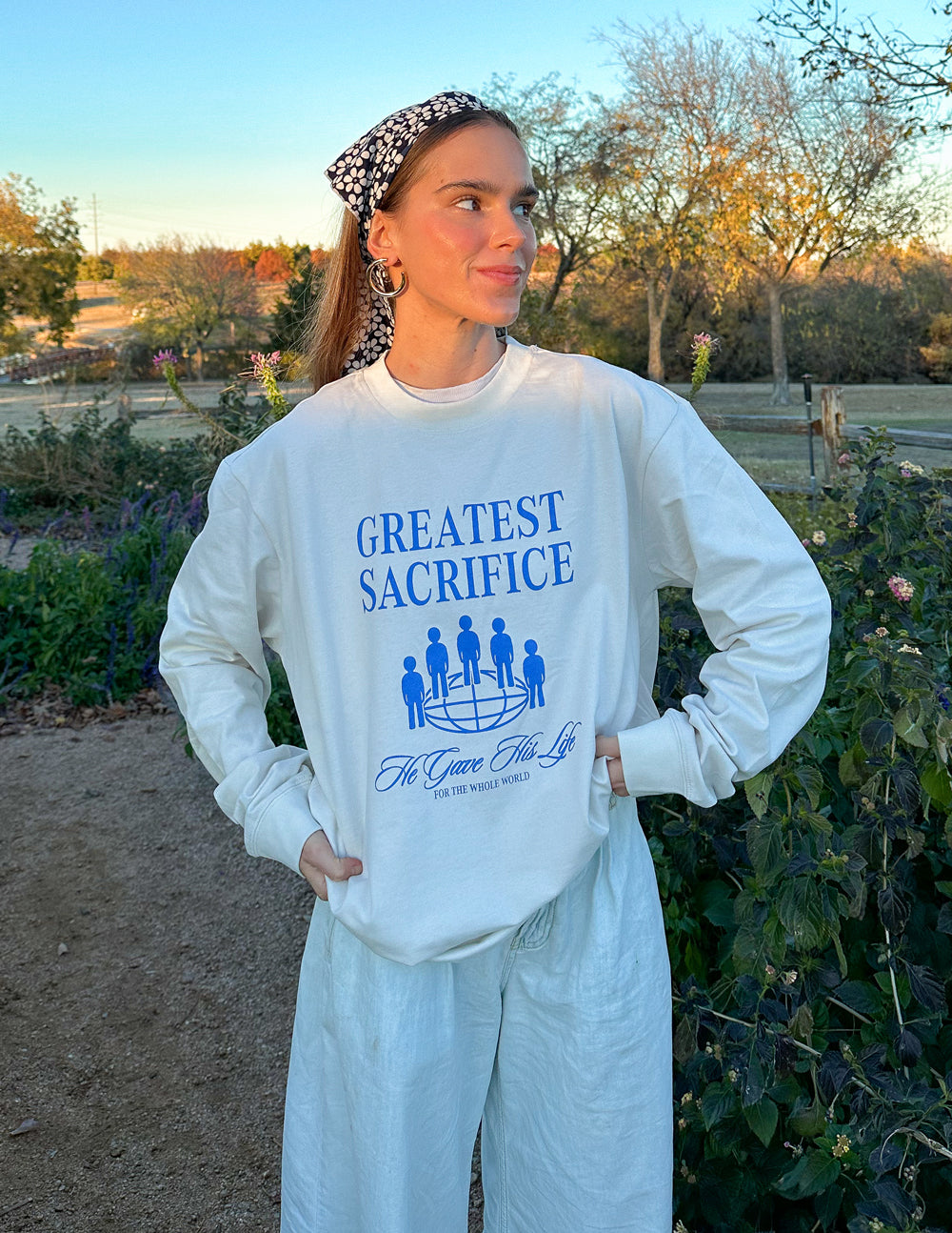 White long-sleeve unisex T-shirt with blue “Greatest Sacrifice” graphic and cuffs