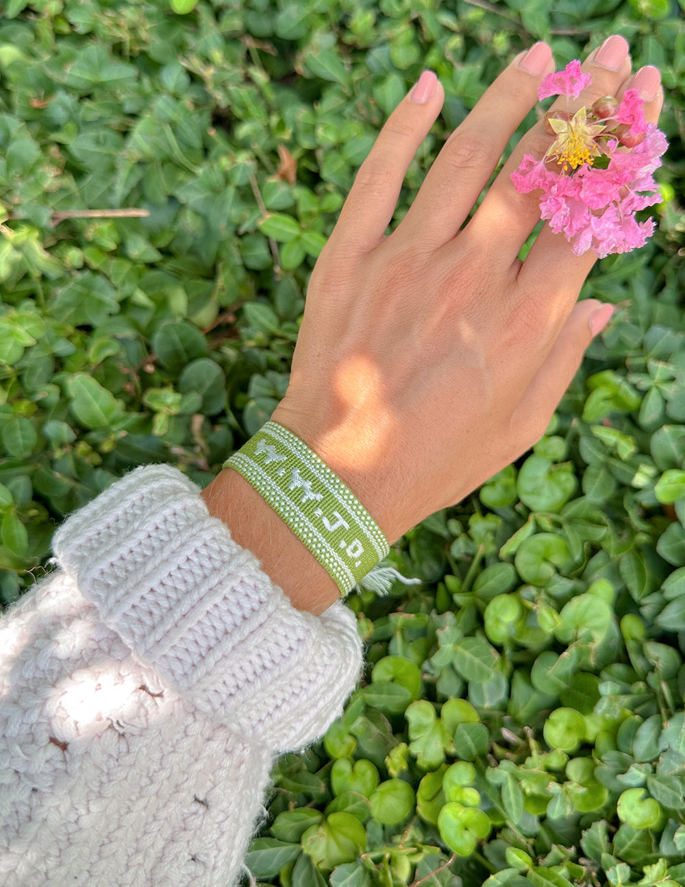 Green embroidered bracelet with tassels on wrist