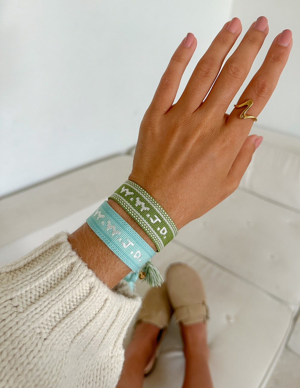 Blue embroidered bracelet with tassels on wrist