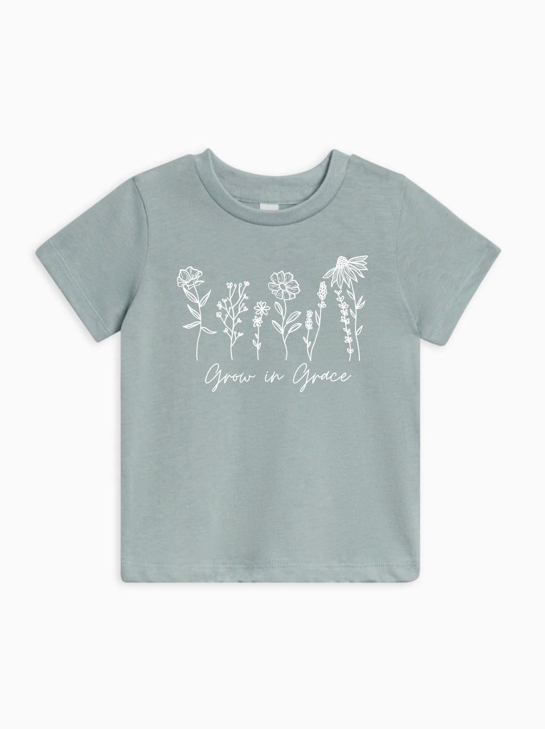 Kids organic cotton T-shirt in sage green with white wildflower graphic and Grow in Grace text.