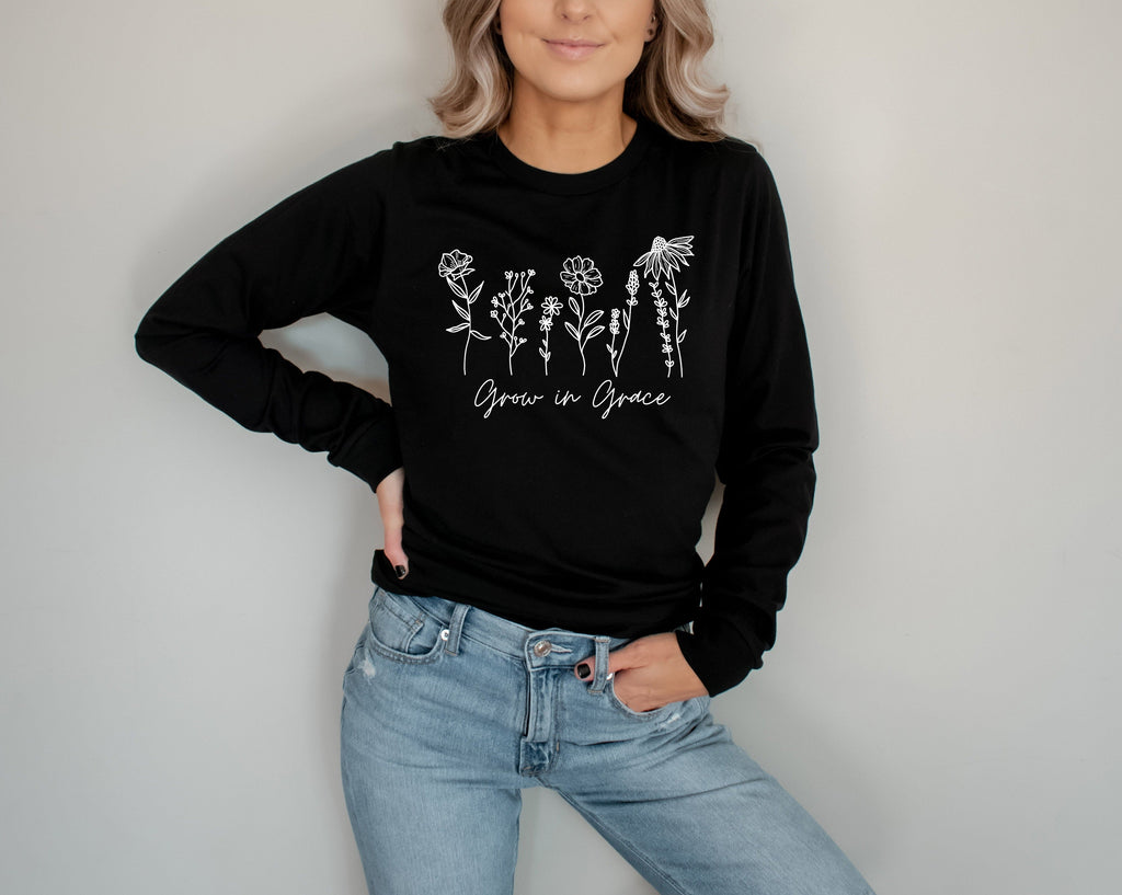 Black long sleeve T-shirt with white botanical “Grow in Grace” graphic