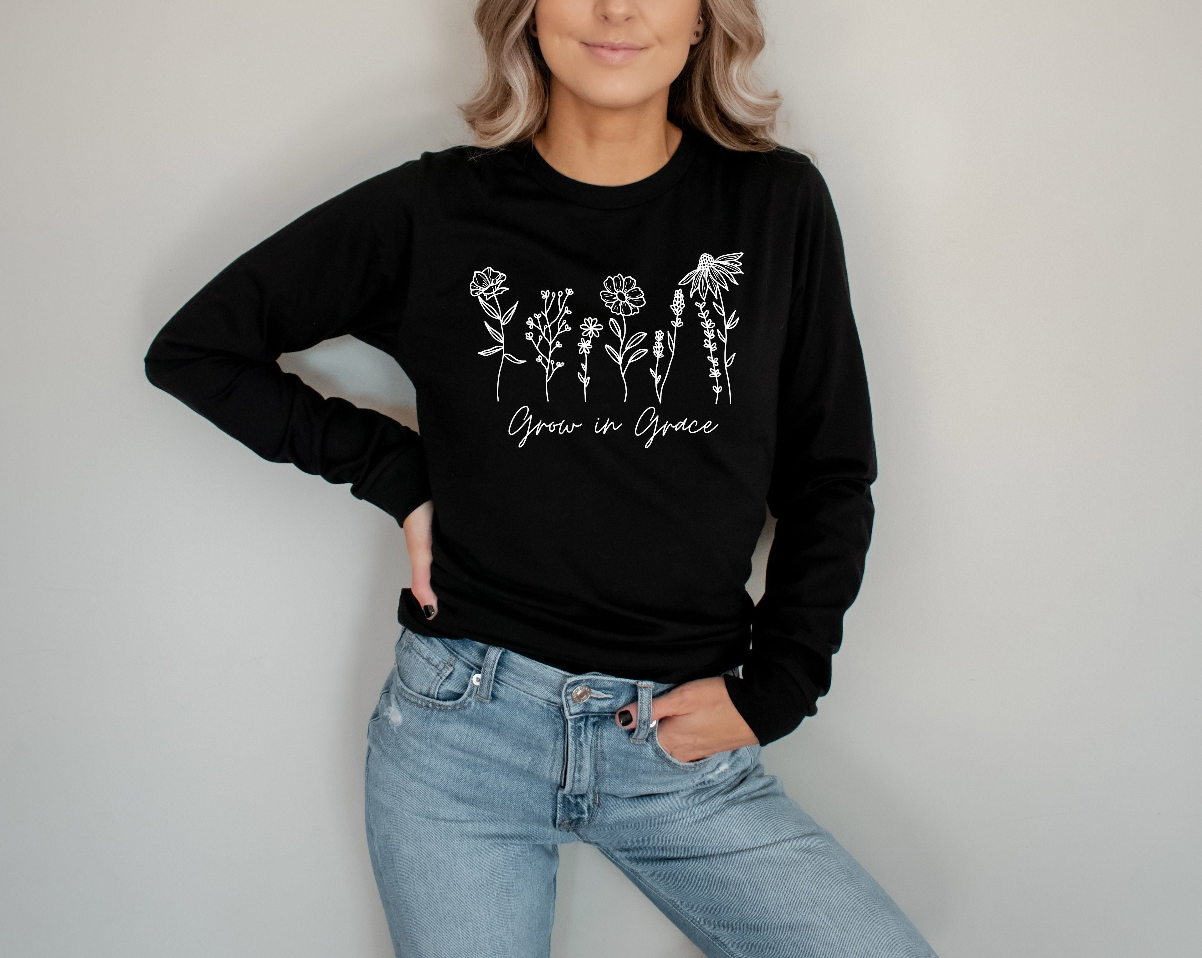Black long sleeve T-shirt with white botanical “Grow in Grace” graphic