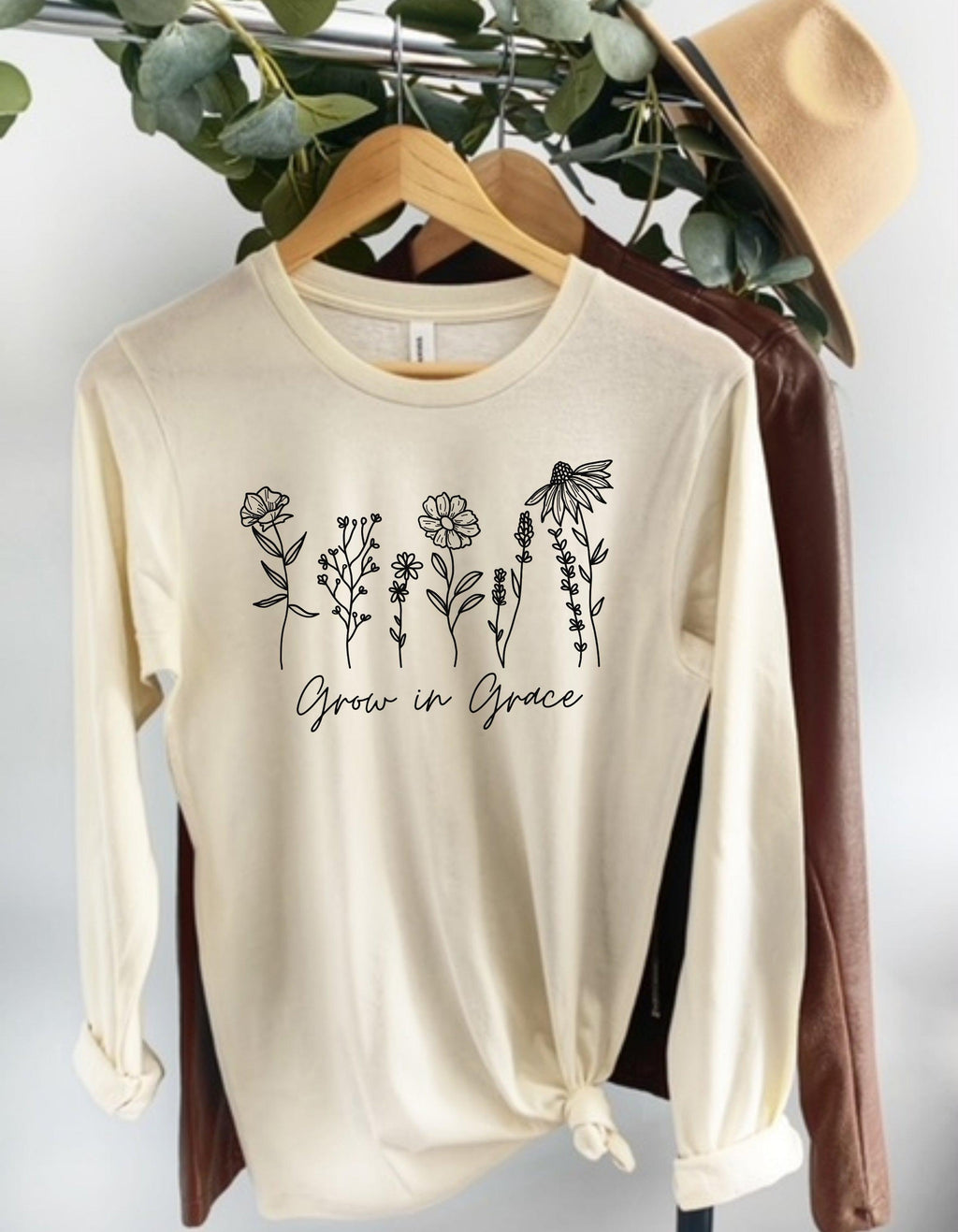 Natural long sleeve T-shirt with white botanical “Grow in Grace” graphic