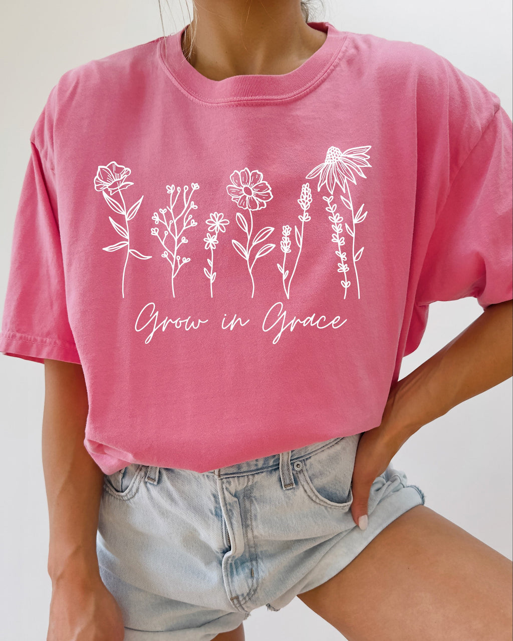 Pink berry unisex graphic t-shirt with white floral “Grow in Grace” print