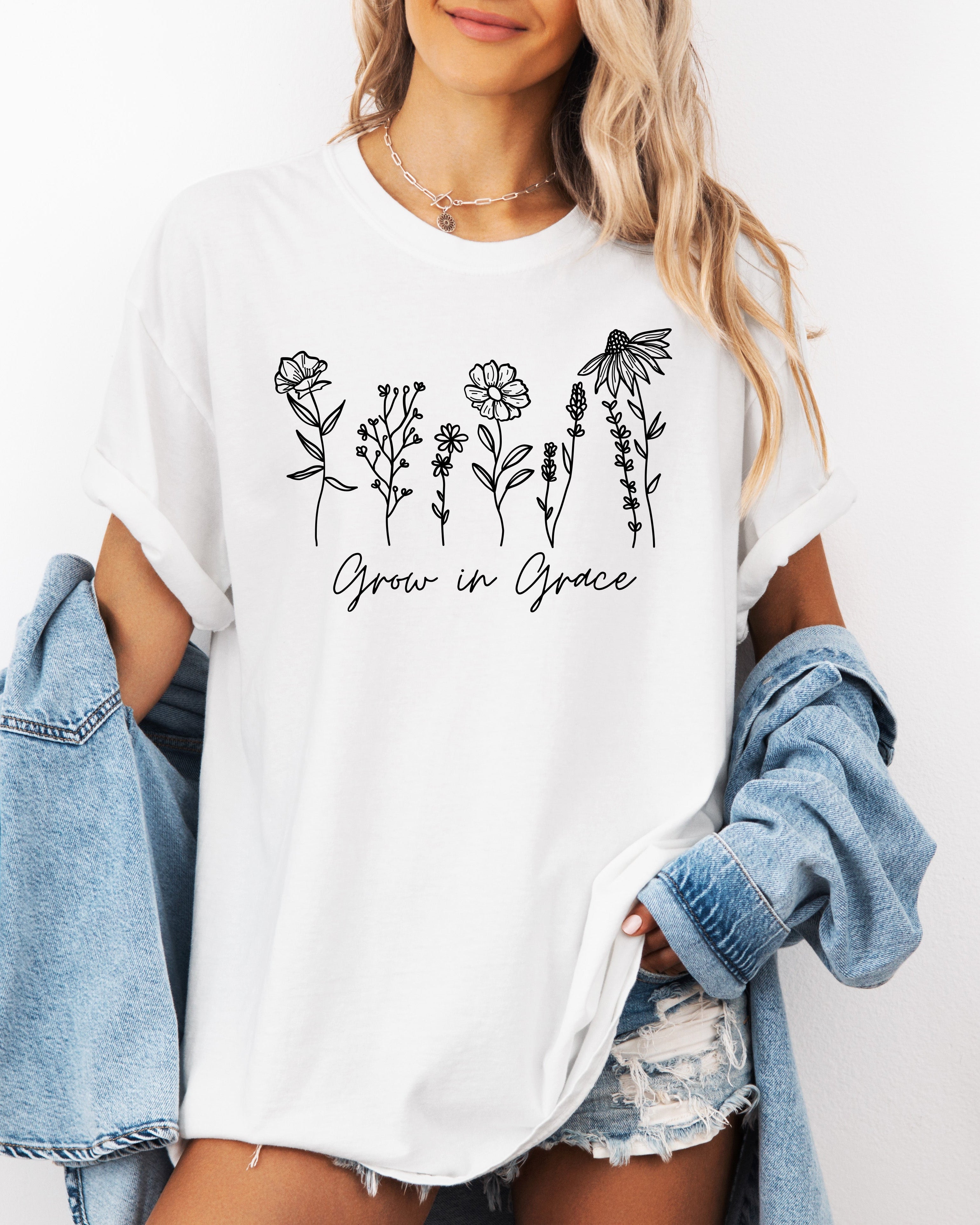 White unisex graphic t-shirt with black floral “Grow in Grace” print on front