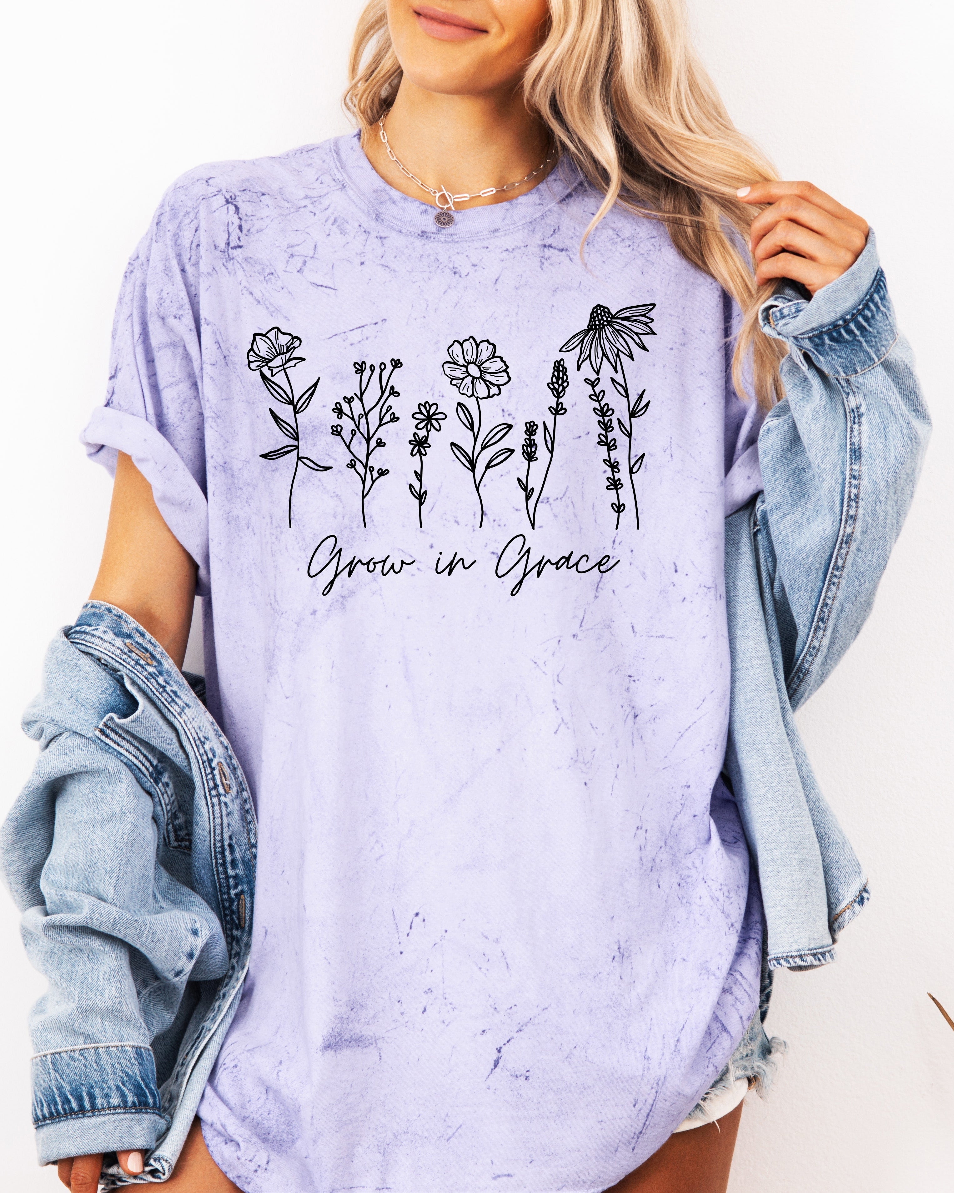 Purple unisex graphic t-shirt with dark floral “Grow in Grace” print across chest