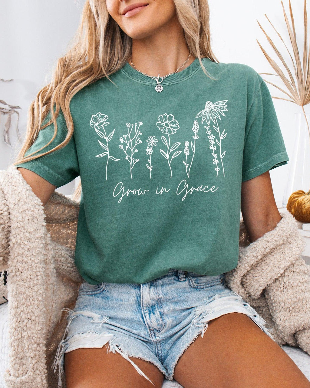 Green T-shirt with floral 'Grow in Grace' graphic