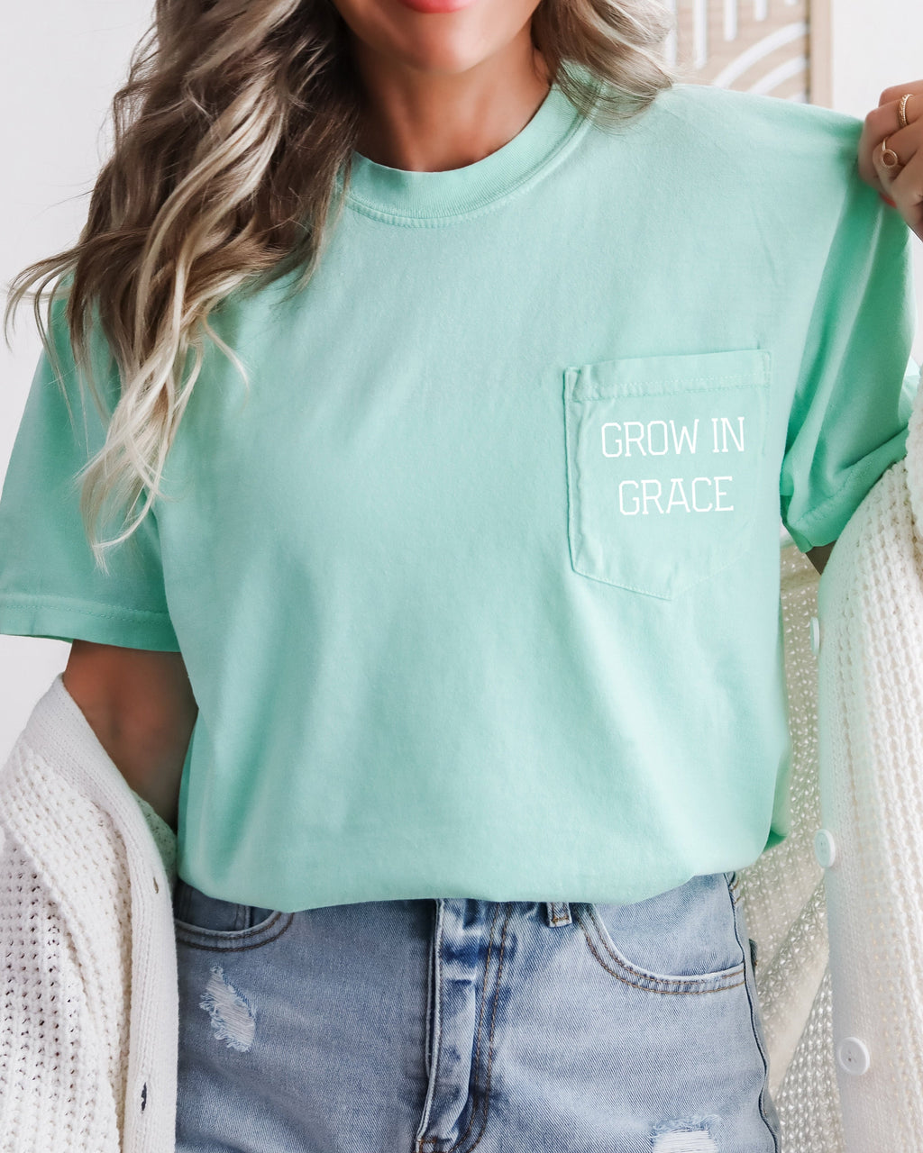Women's mint green pocket T-shirt with 'Grow in Grace' text graphic