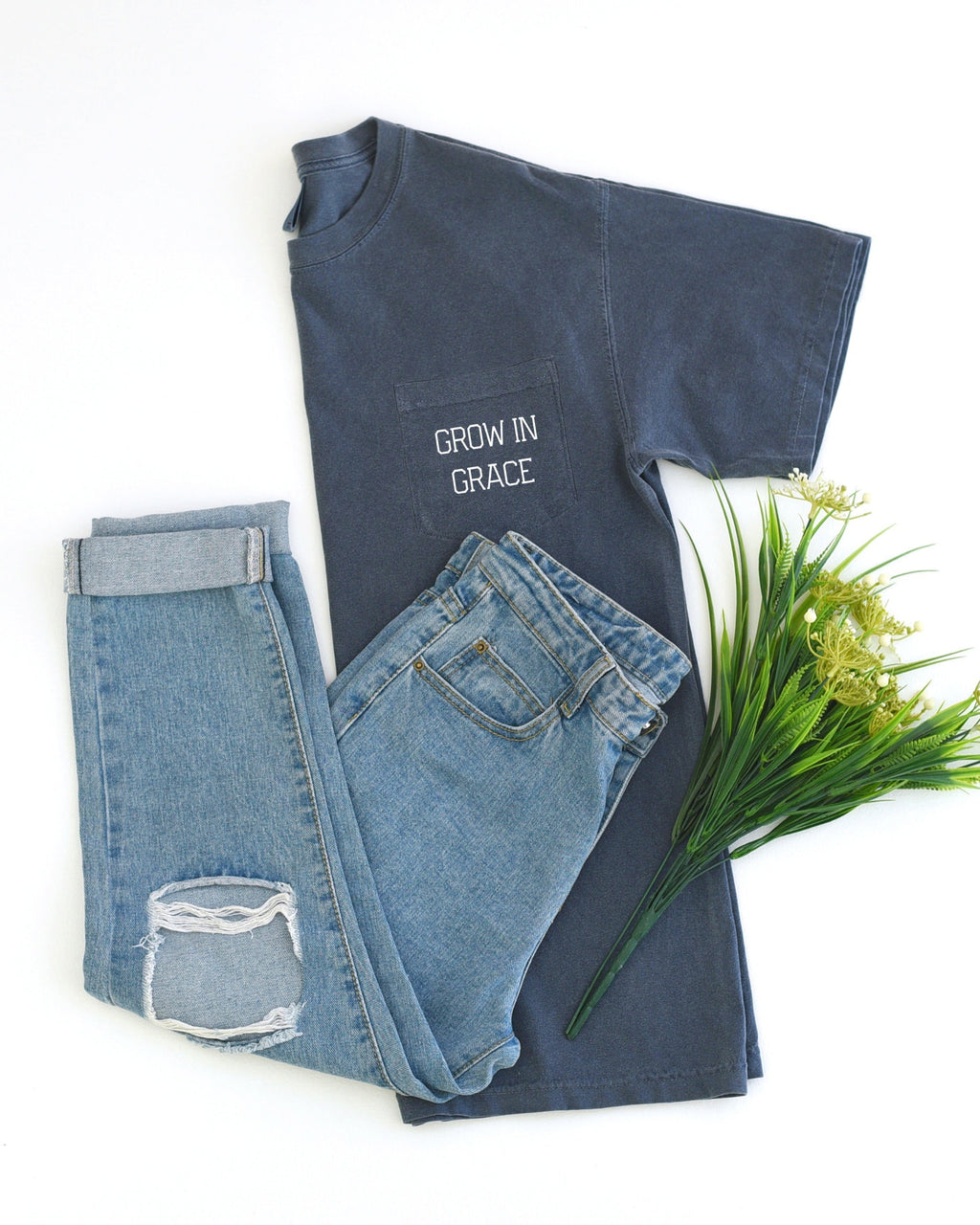 Dark pocket t-shirt with "Grow in Grace" chest graphic.
