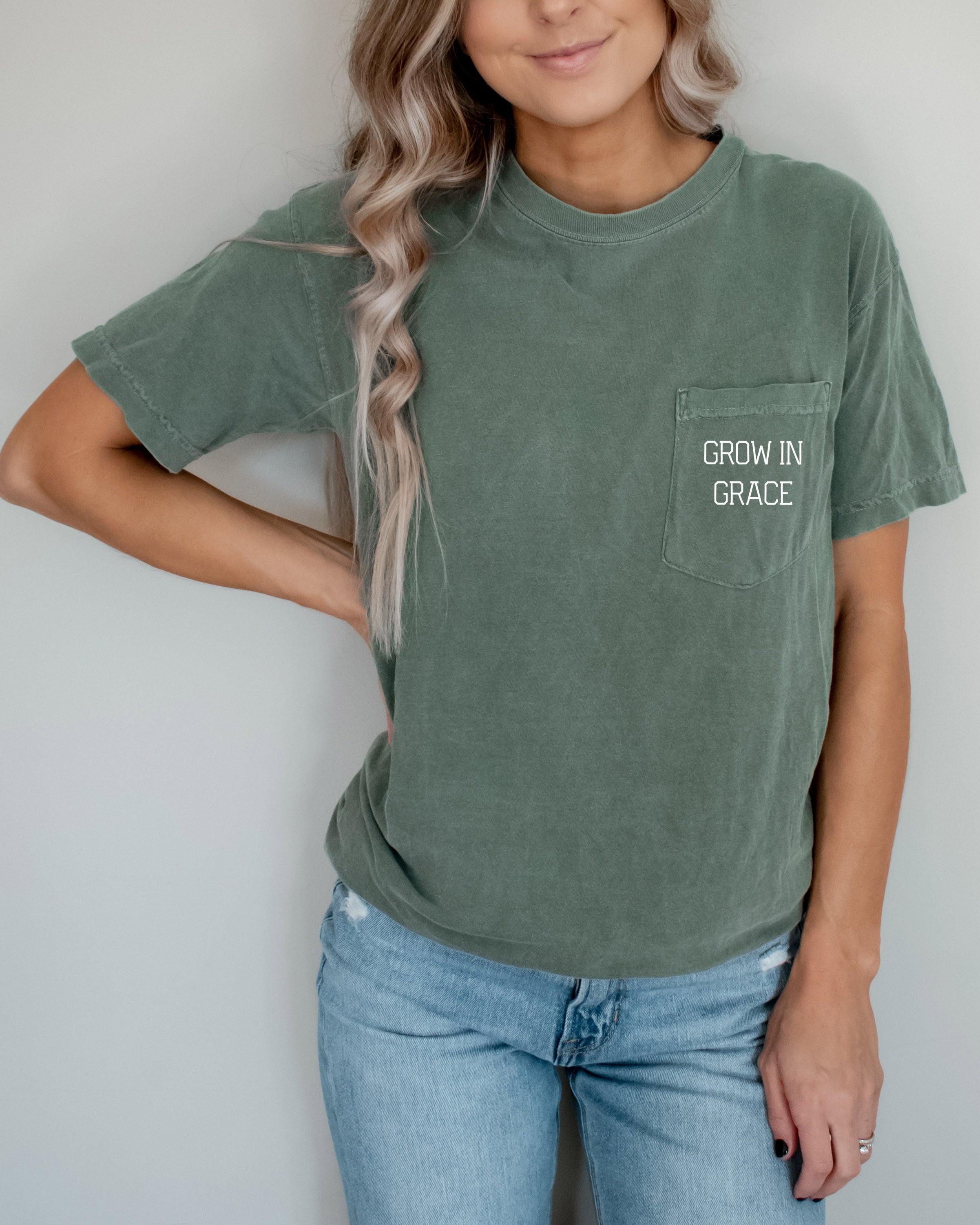 Women's moss green pocket T-shirt with 'Grow in Grace' text graphic