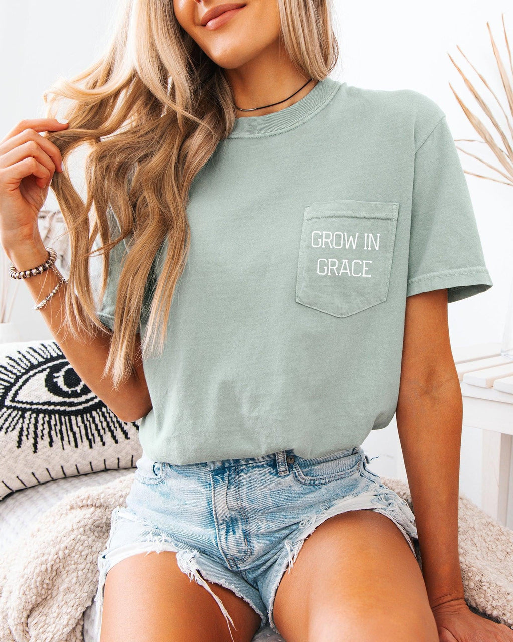 Women's moss green pocket T-shirt with 'Grow in Grace' text graphic