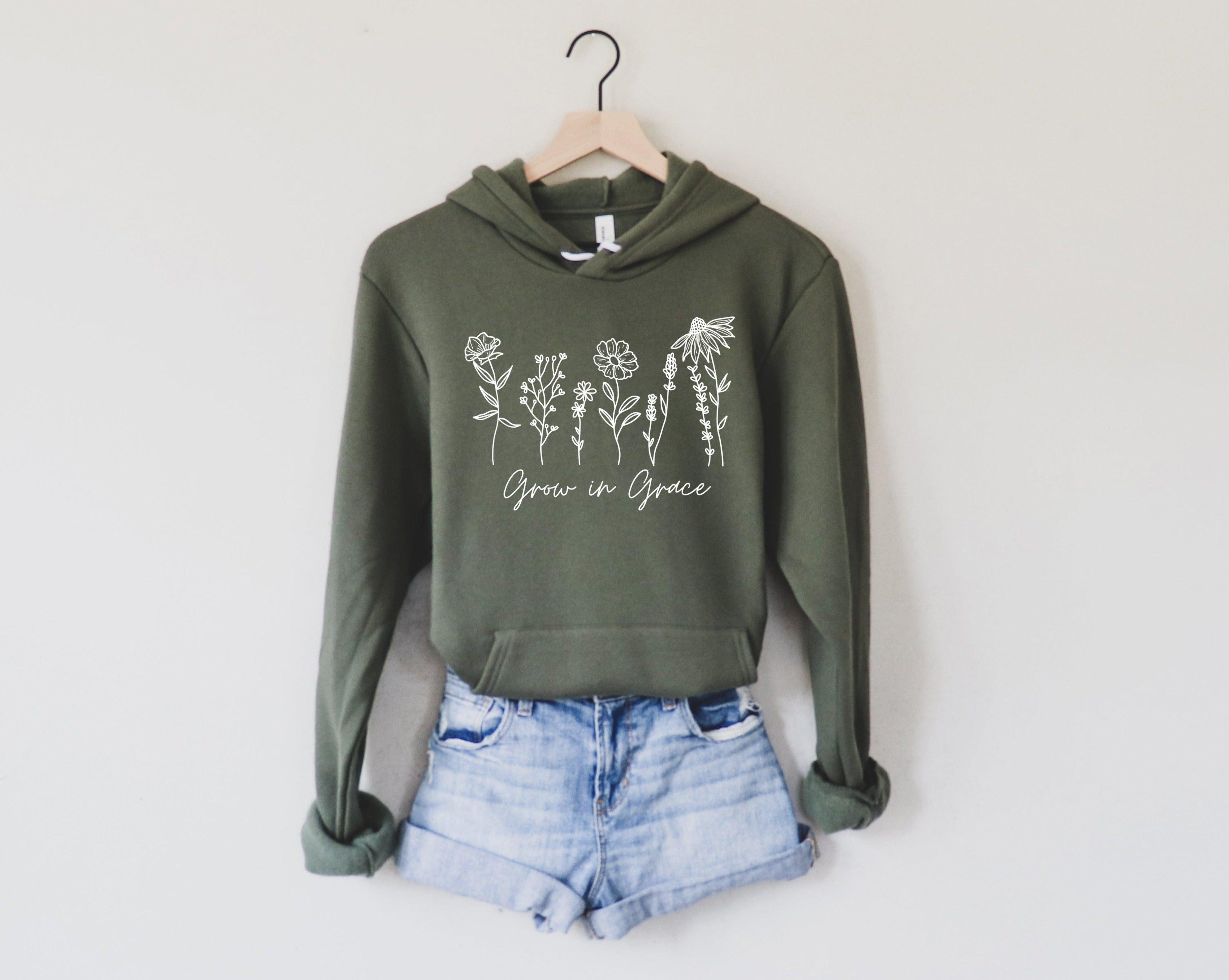 Military green sponge fleece hoodie with white wildflower text graphic on front