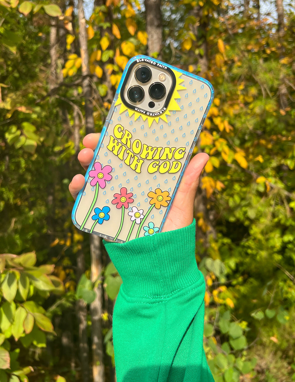 Blue phone case with flower and sunburst graphic, 'Growing With God' text