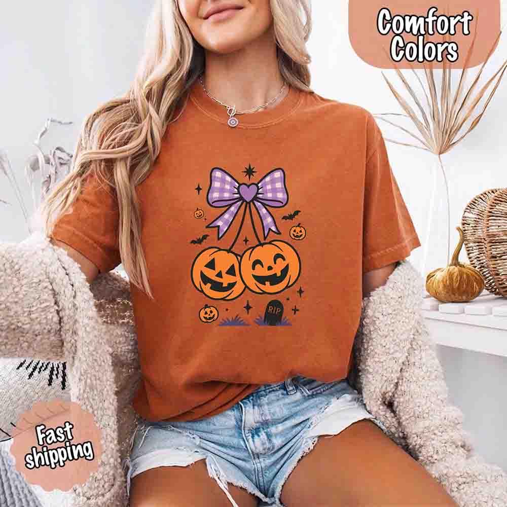 Rust brown Halloween graphic T-shirt with purple bow and orange jack-o’-lantern pumpkins