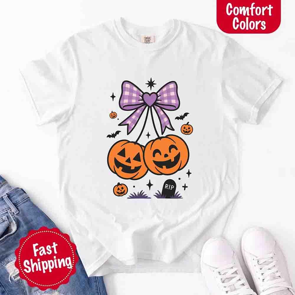 White Halloween graphic T-shirt with purple bow and orange jack-o’-lantern pumpkins