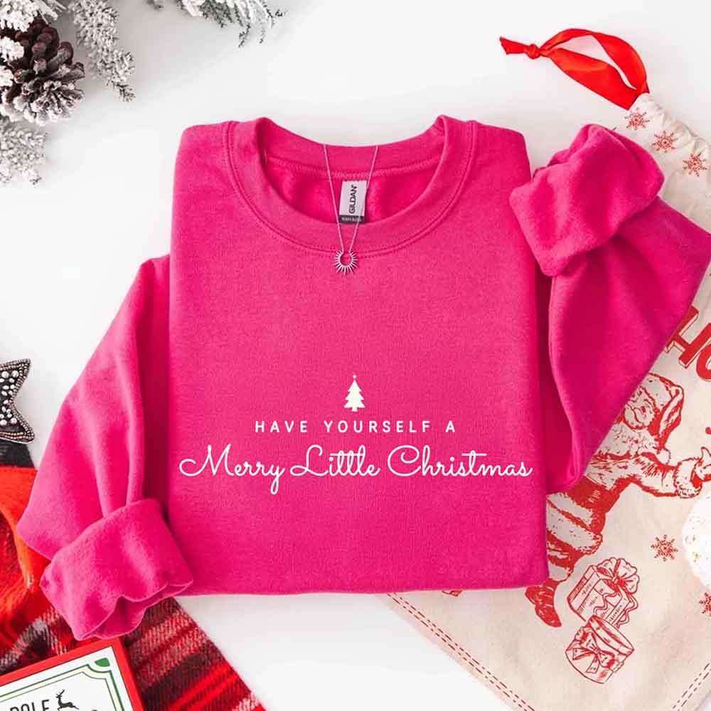 Hot pink crew-neck sweatshirt with Merry Little Christmas text and tree graphic