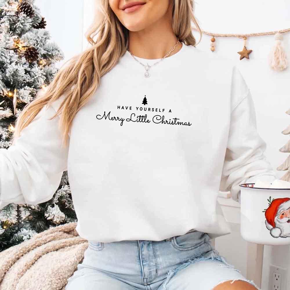 White crewneck sweatshirt on model with holiday tree and cursive text