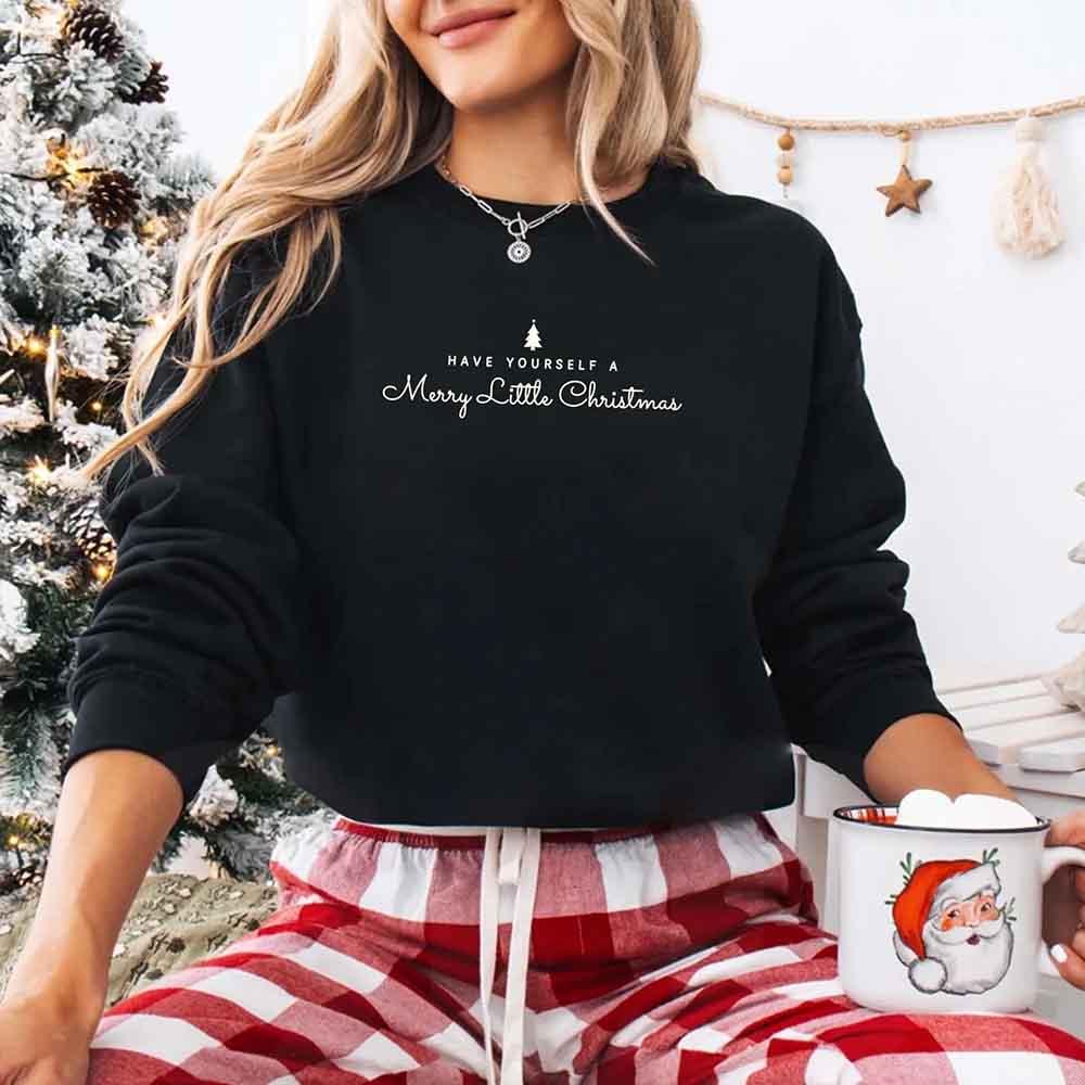 Black crew-neck sweatshirt with Merry Little Christmas text and small tree graphic