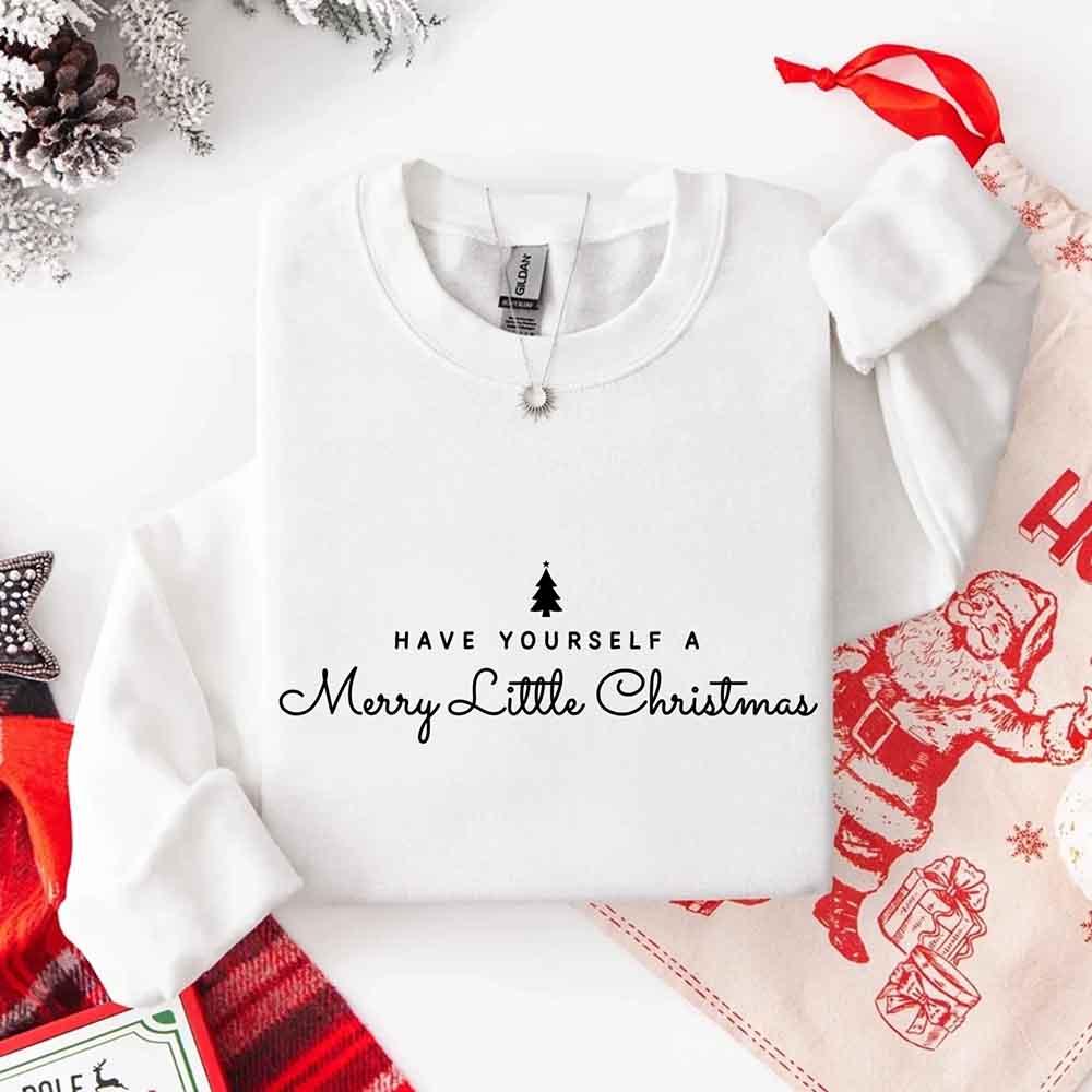White crewneck sweatshirt with holiday text and tree graphic, long sleeves