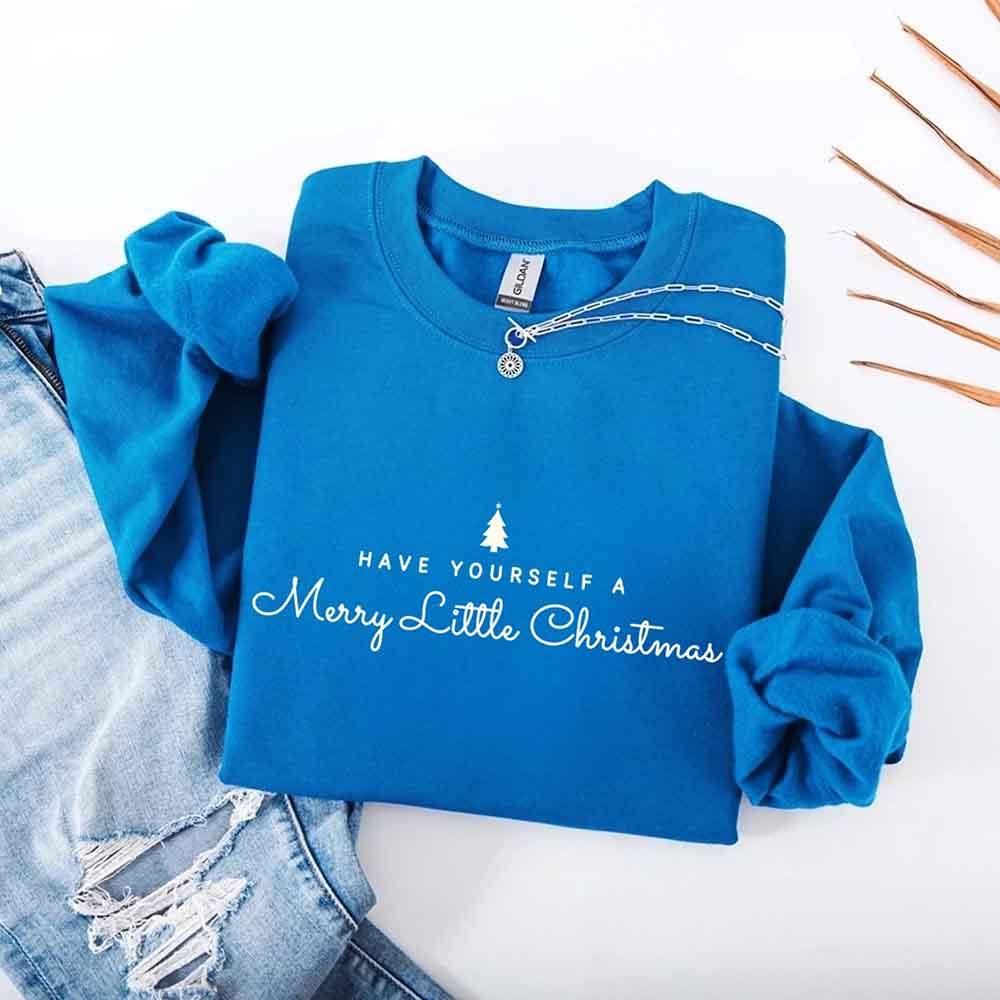 Blue crewneck sweatshirt with Merry Little Christmas graphic on chest