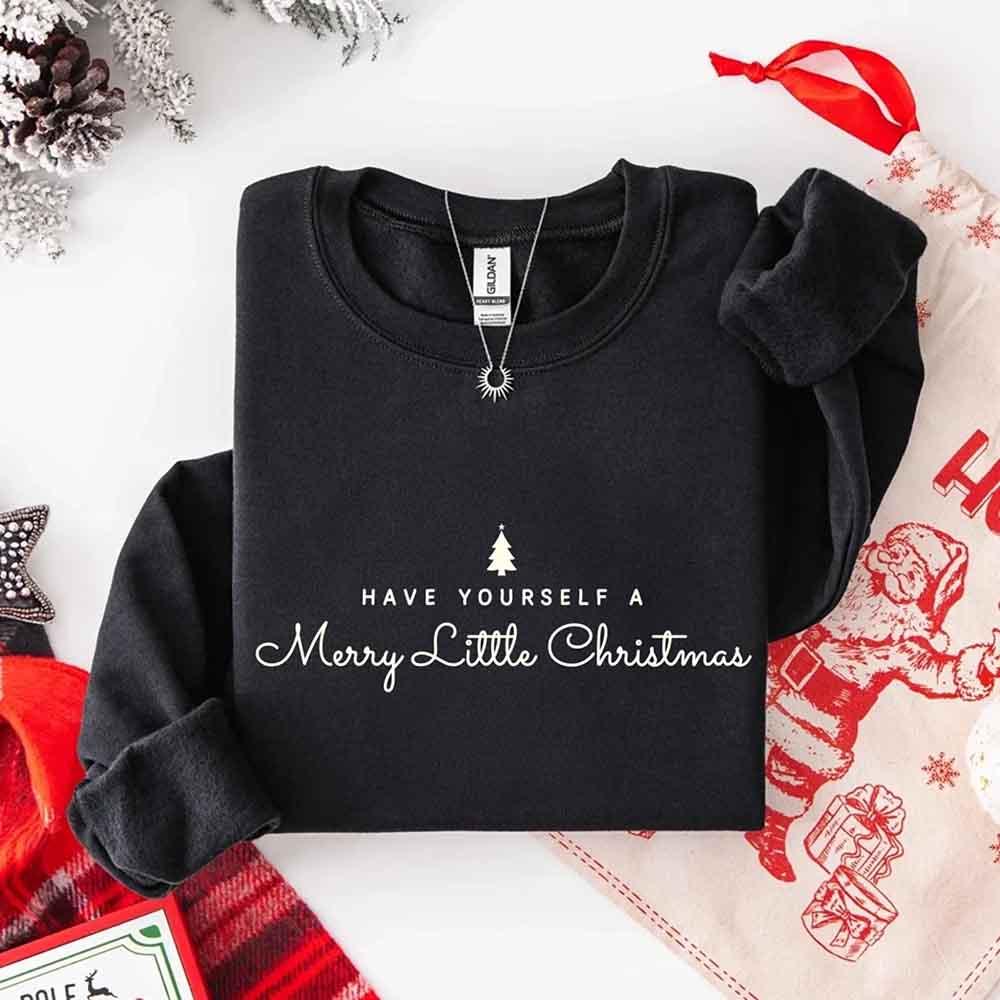 Black crewneck sweatshirt with holiday tree and Merry Little Christmas text