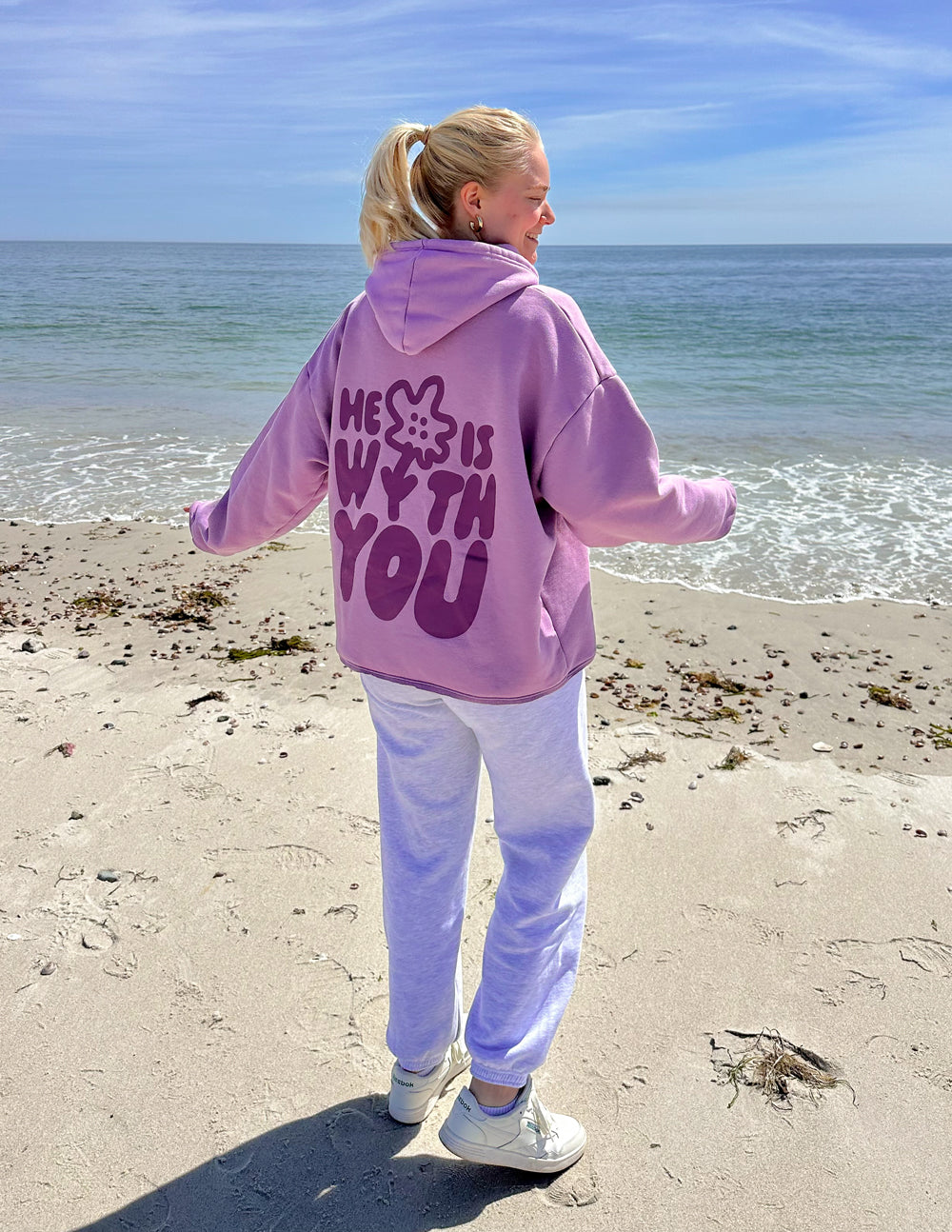 Lilac unisex hoodie with large back graphic on beach, pullover hood