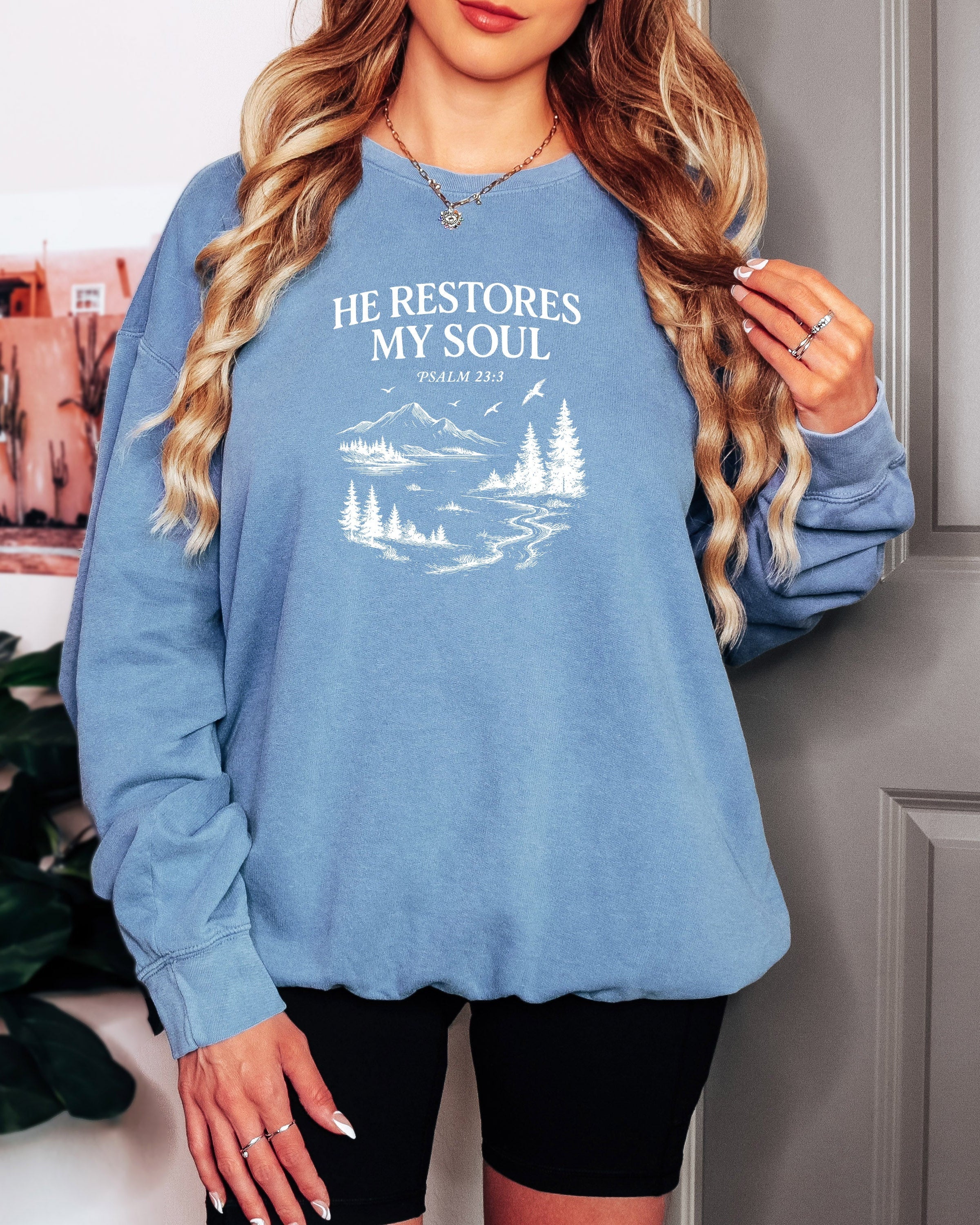 Dyed blue jean sweatshirt with “He Restores My Soul” Psalm 23:3 forest graphic