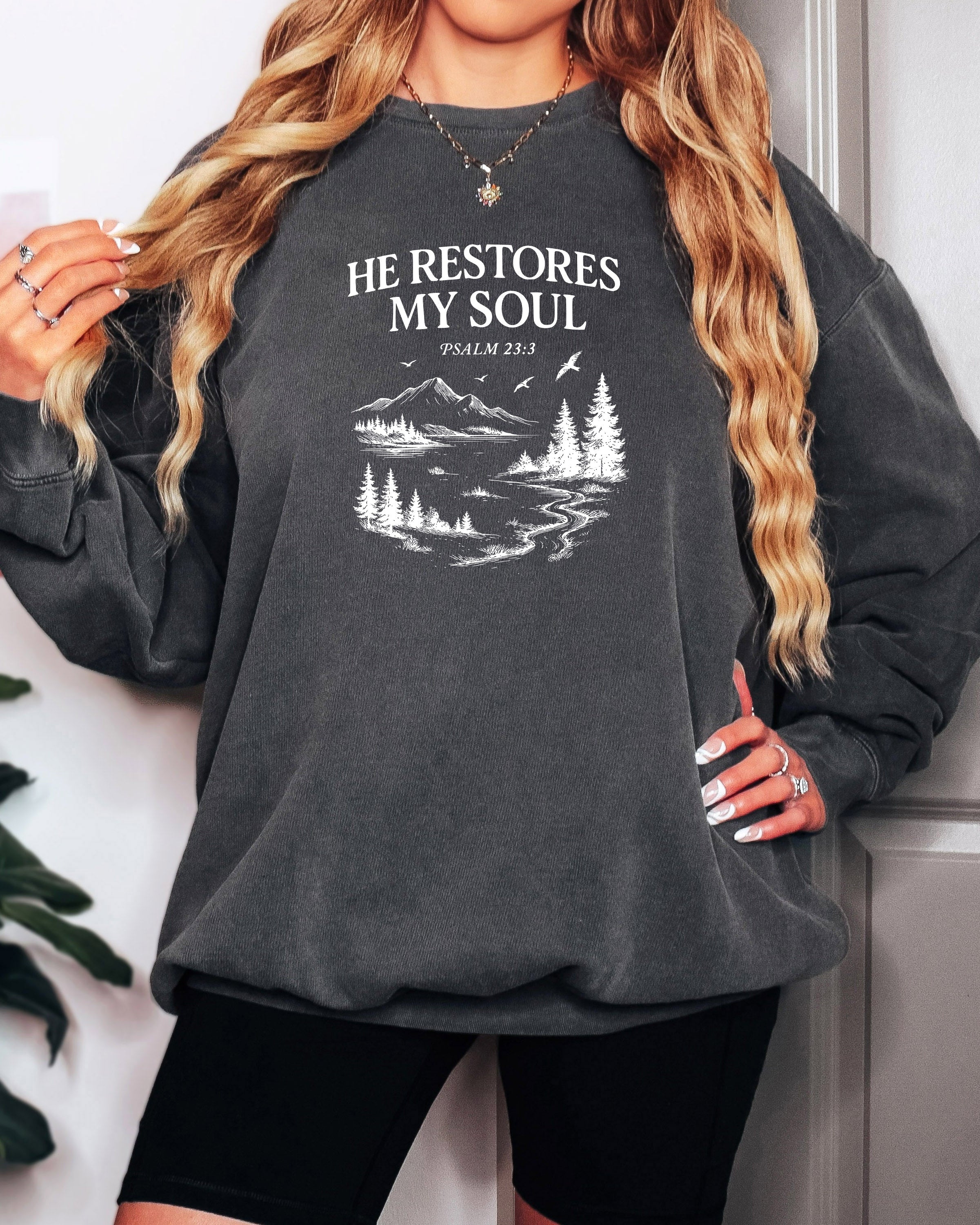 Dyed pepper black sweatshirt with “He Restores My Soul” Psalm 23:3 forest graphic
