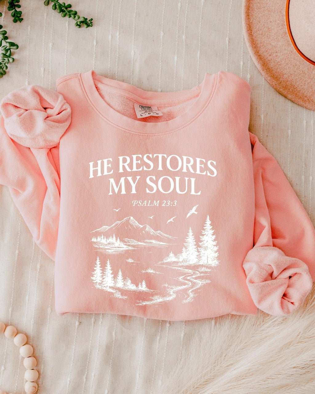 Dyed blush sweatshirt with “He Restores My Soul” Psalm 23:3 forest graphic