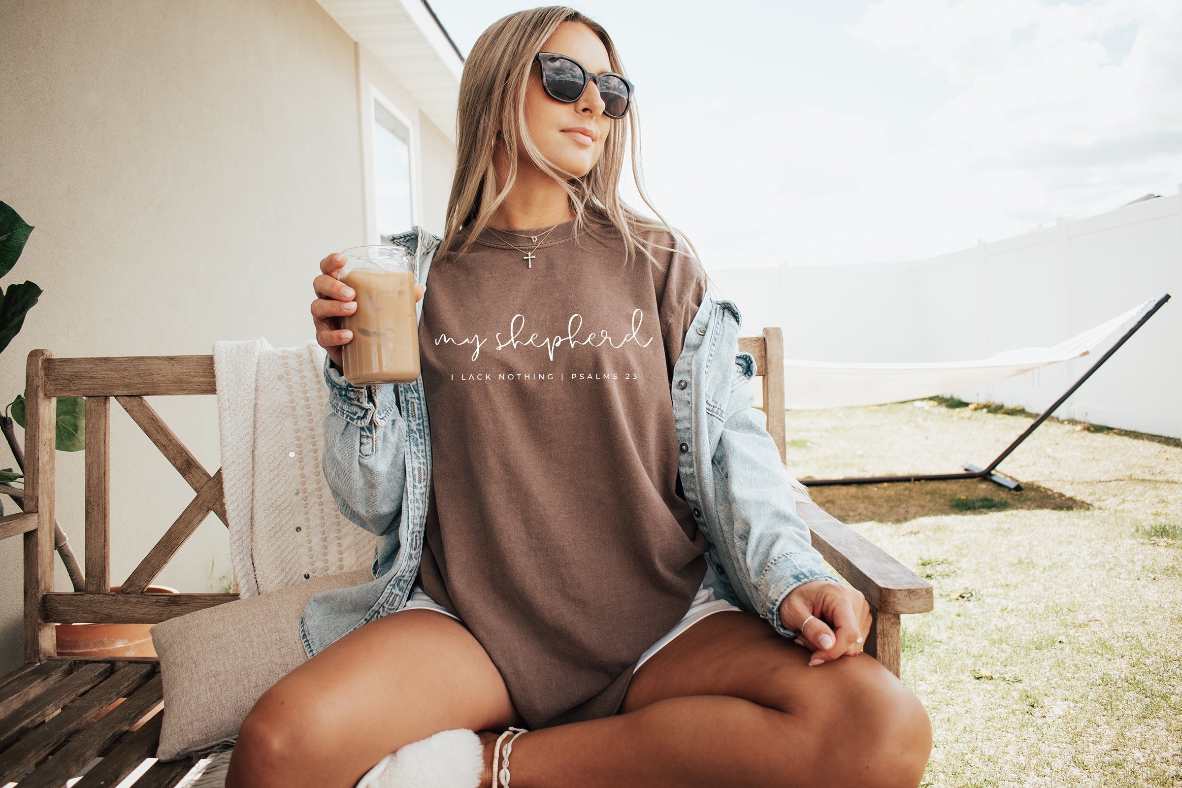 Brown T-shirt with front script graphic and small verse text printed across the chest