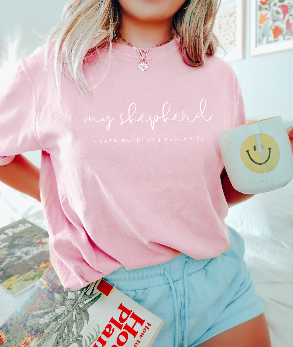Pink T-shirt with script graphic and small verse text printed across the front