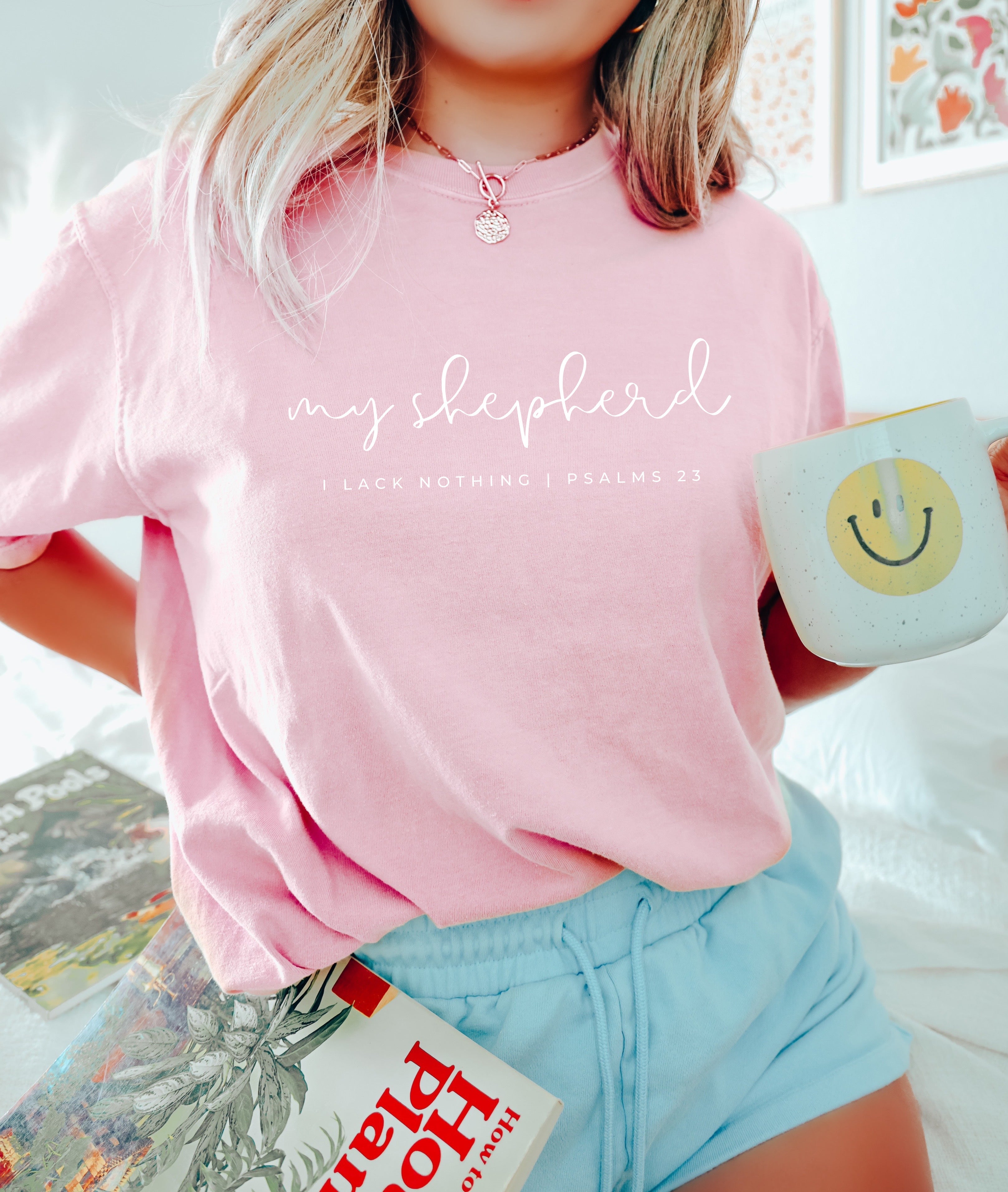Pink T-shirt with script graphic and small verse text printed across the front