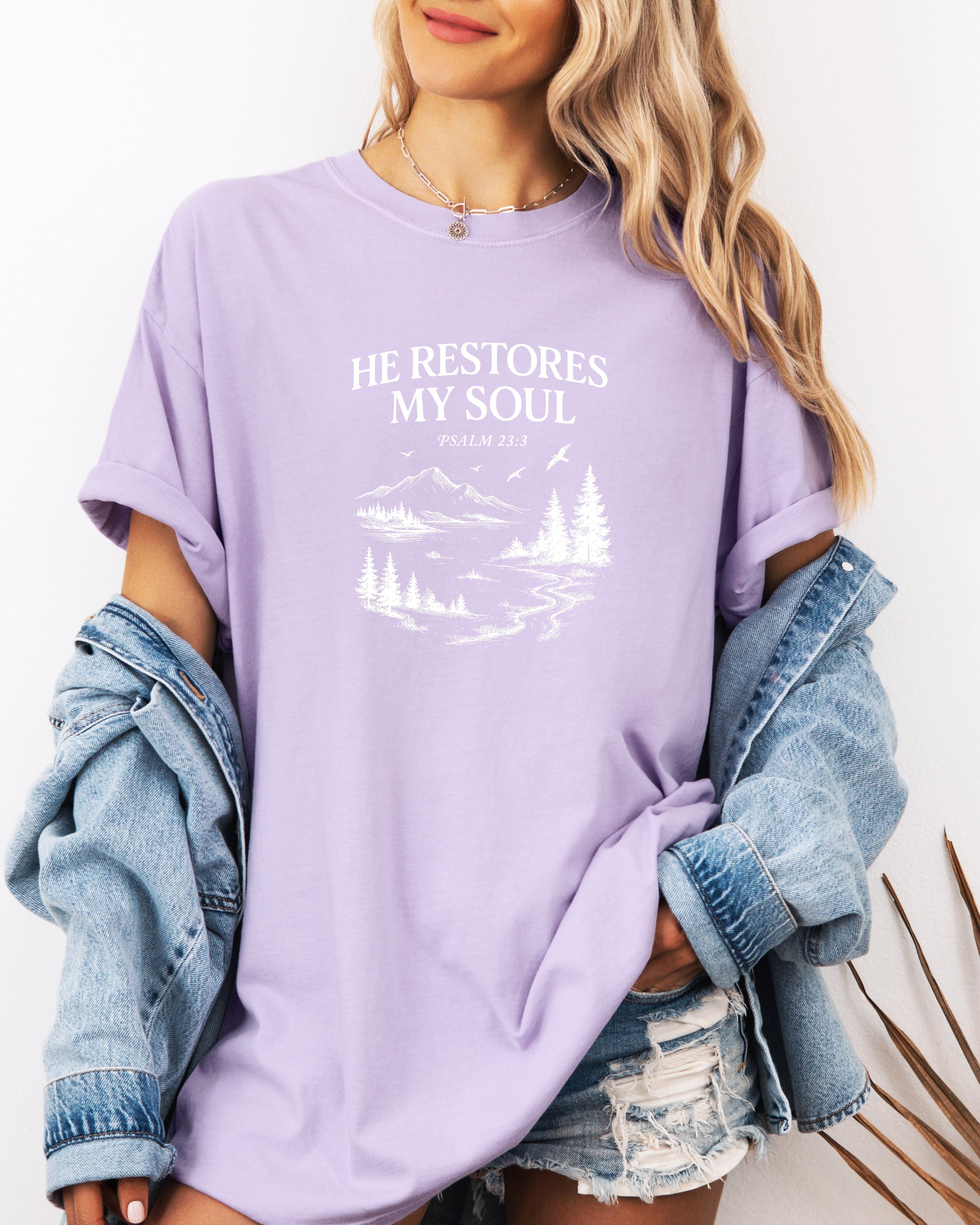 Lavender Christian graphic T-shirt with 'He restores my soul' mountain and tree print