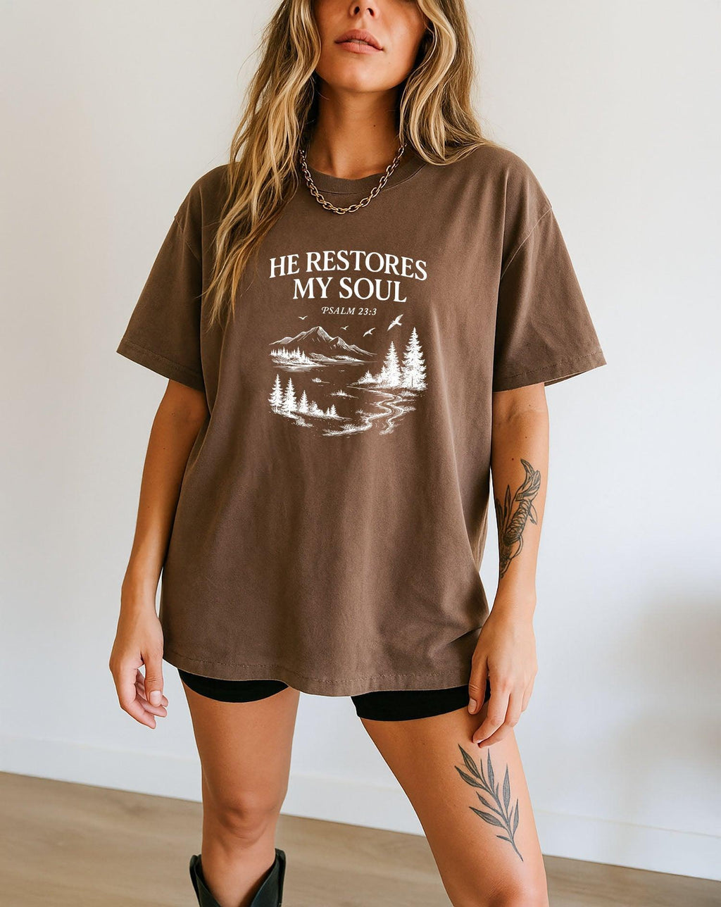 Mocha brown unisex T-shirt with white “He Restores My Soul” mountain landscape graphic