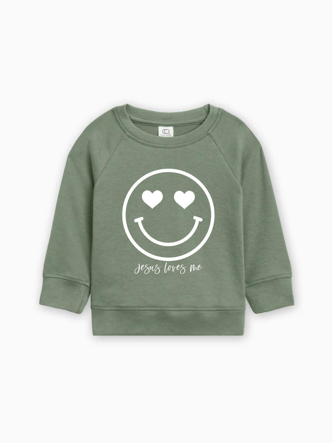 Green kids organic cotton pullover with white heart smiley graphic and 'Jesus loves me'