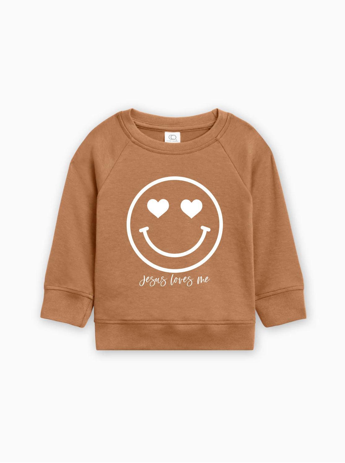 Brown kids organic cotton pullover with white heart smiley graphic and 'Jesus loves me'
