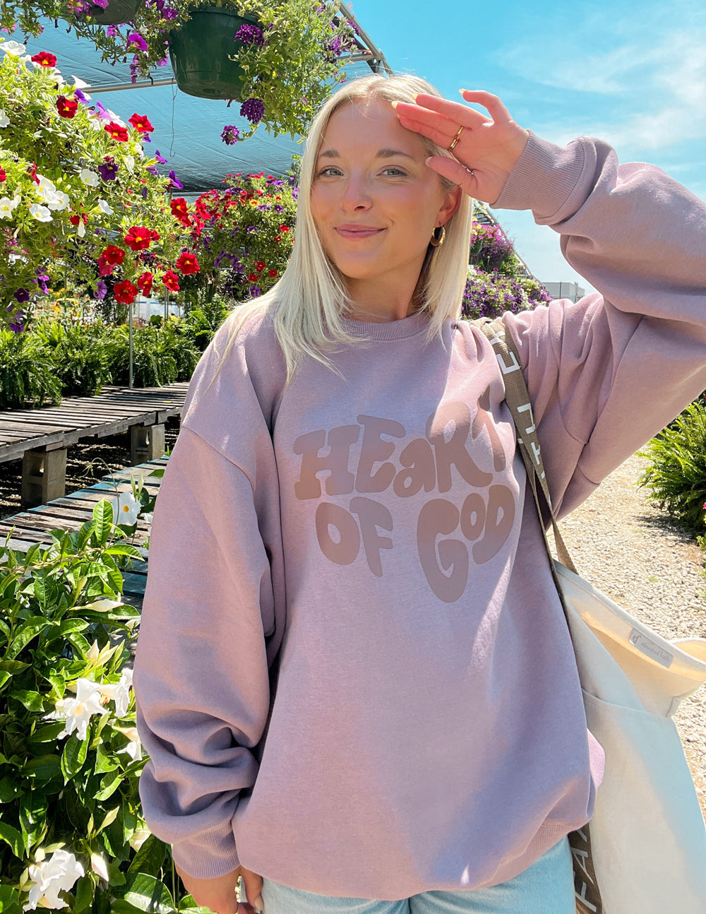 Mauve unisex crewneck sweatshirt with Heart of God graphic at chest