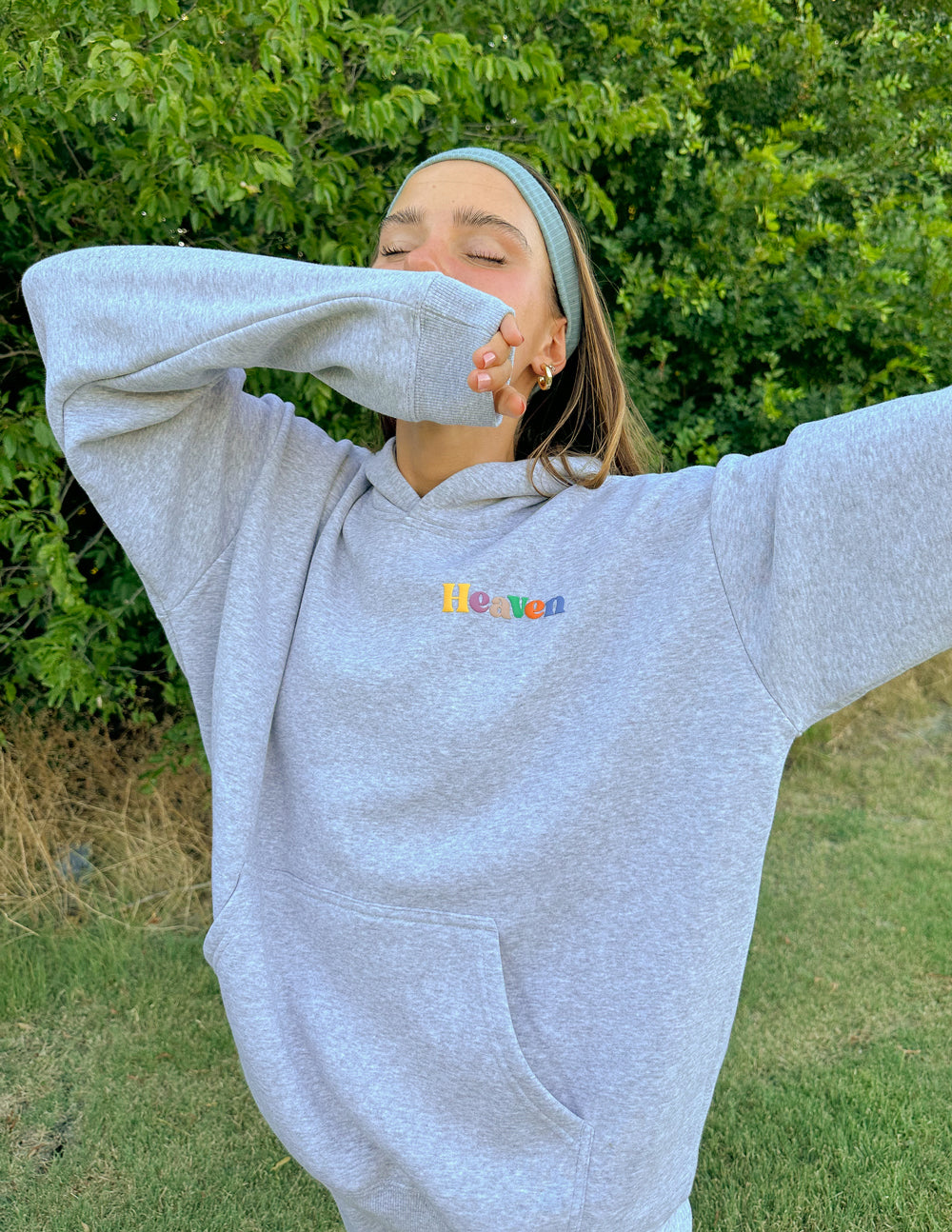 Heather grey unisex hoodie with hood, kangaroo pocket, and Heaven logo on chest
