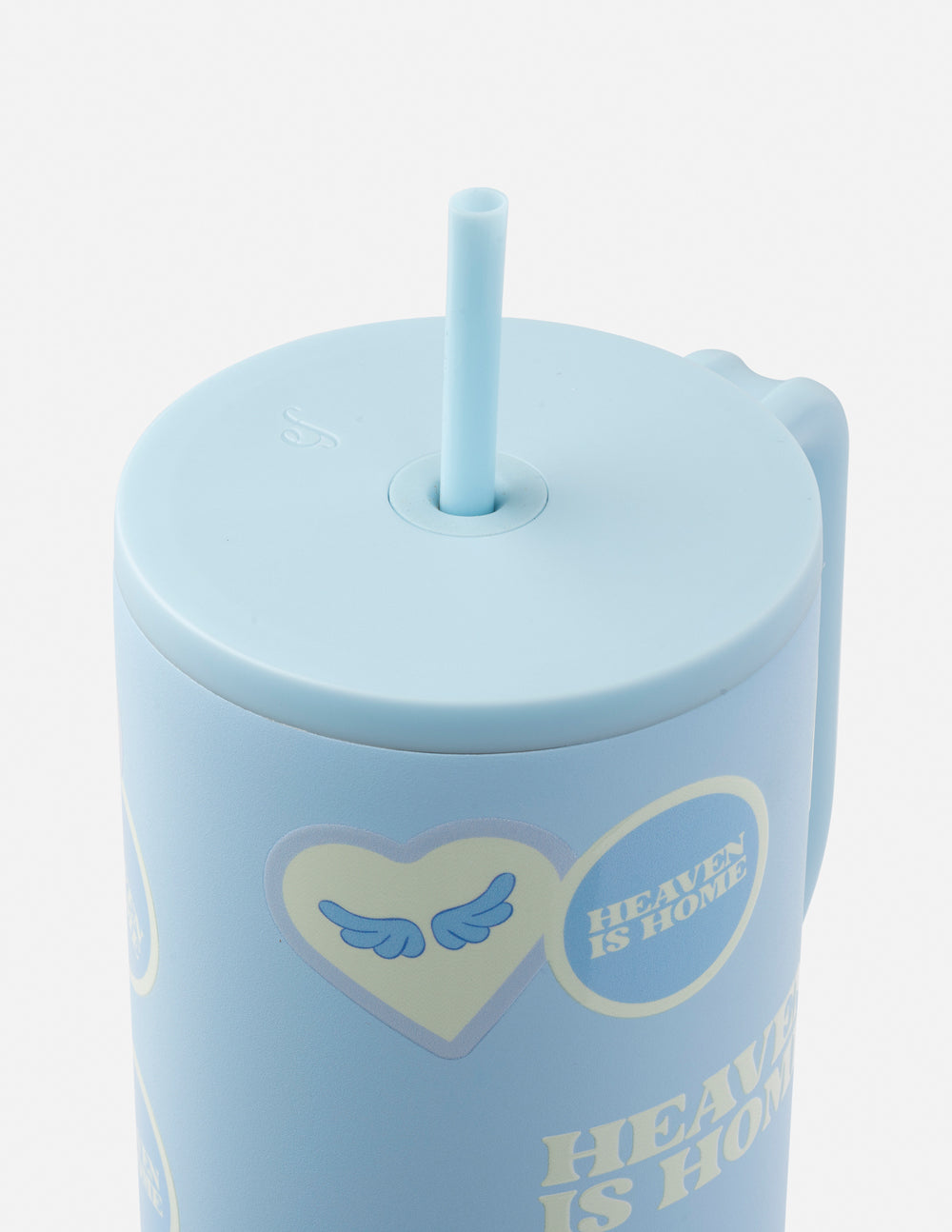 Light blue tumbler lid with straight straw and printed heart emblem, close-up top view