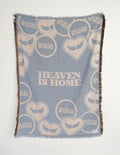 Light blue throw blanket with heart and text pattern, fringed edges