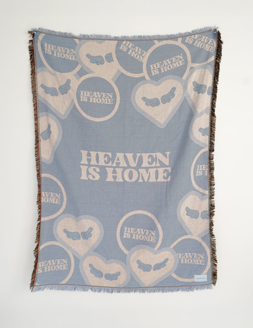 Light blue throw blanket with heart and text pattern, fringed edges