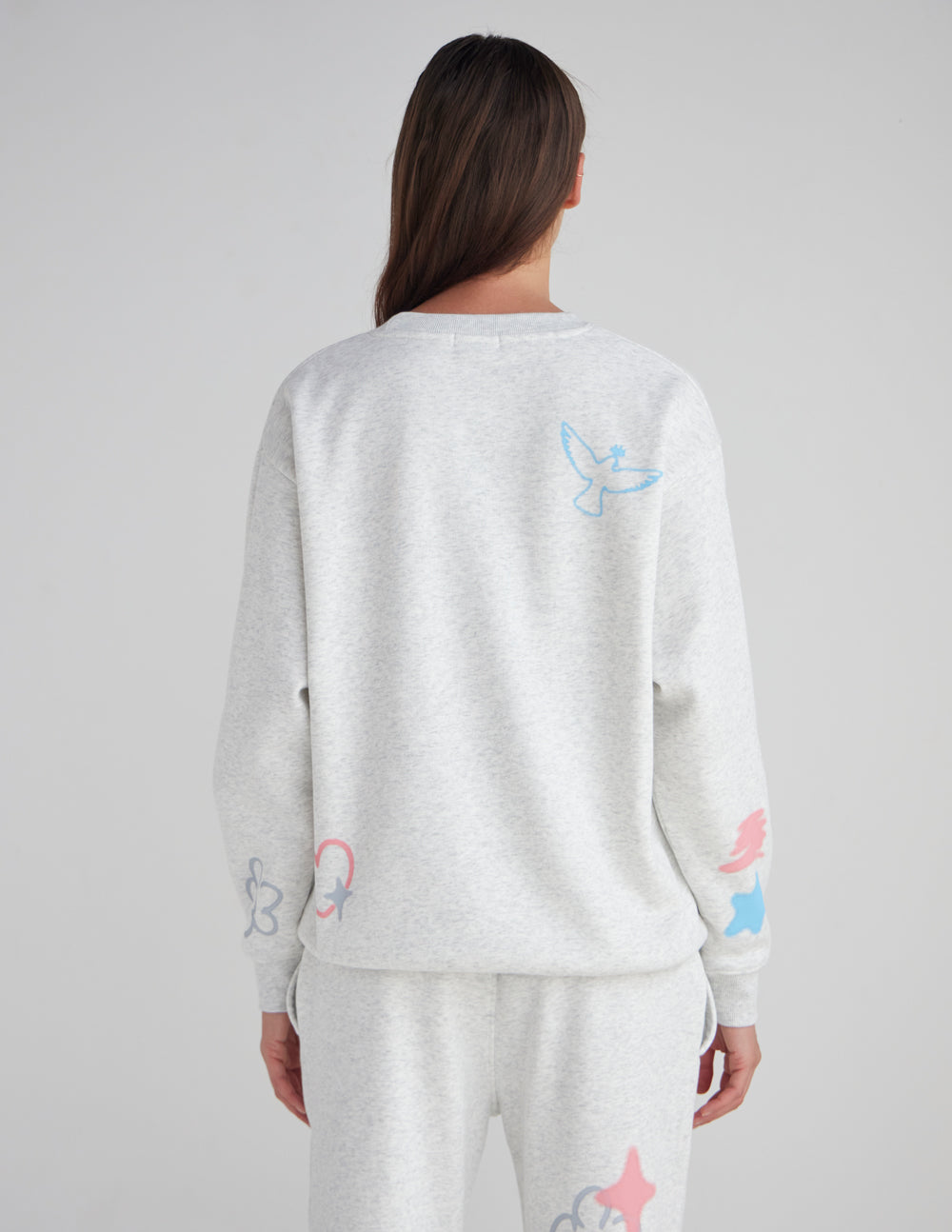 Unisex crewneck sweatshirt and matching sweatpants from back, heather gray with prints