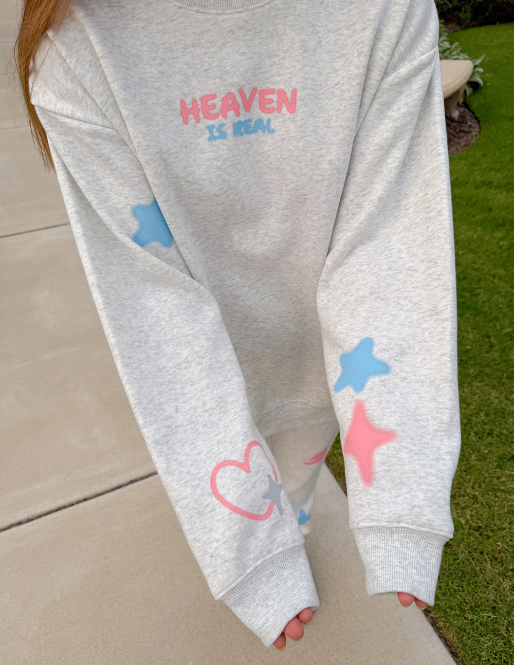 Unisex crewneck sweatshirt set detail: heather gray with cloud and heart graphics
