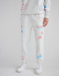 Light gray unisex sweatpants with jogger cuffs and pastel star and heart prints, front logo