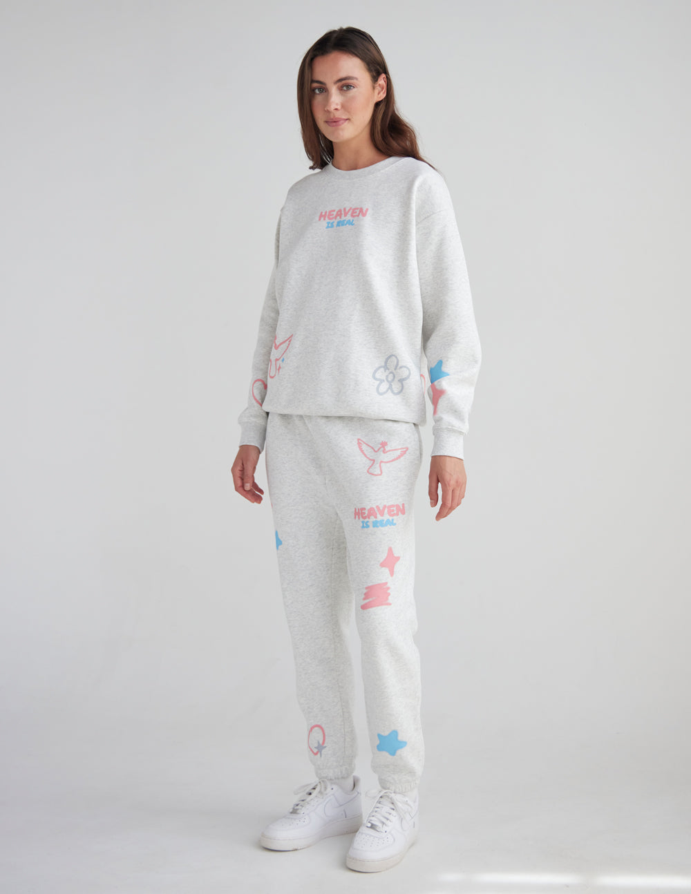 Light gray unisex sweatpants with pastel unicorn, star, and heart graphics and cuffed ankles