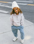 Kids half-zip sweatshirt in white, ribbed collar and cuffs with small chest logo