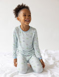 Kids pajama set, light blue long-sleeve top and matching pants with all-over print