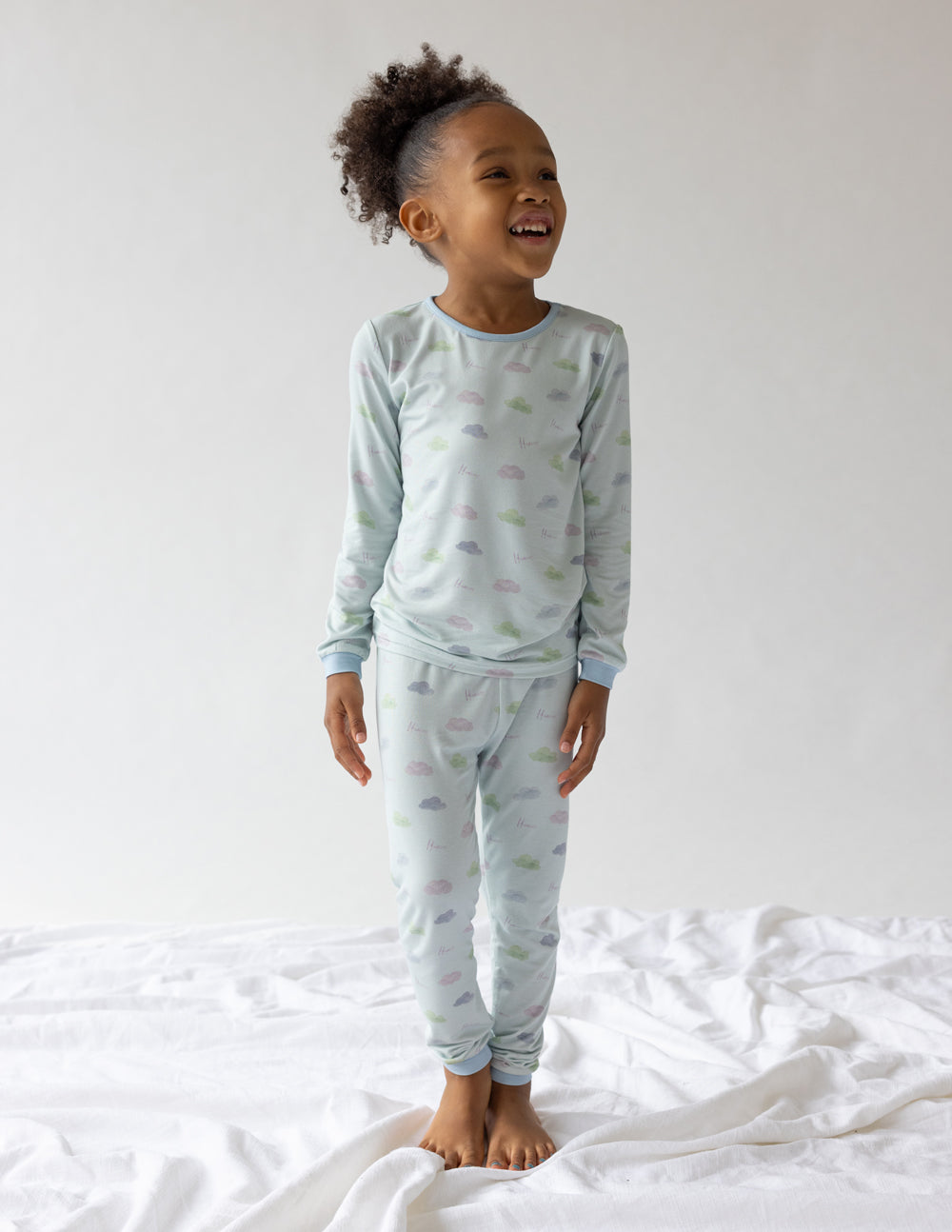 Kids pajama set, light blue long-sleeve top and matching cuffed pants, standing
