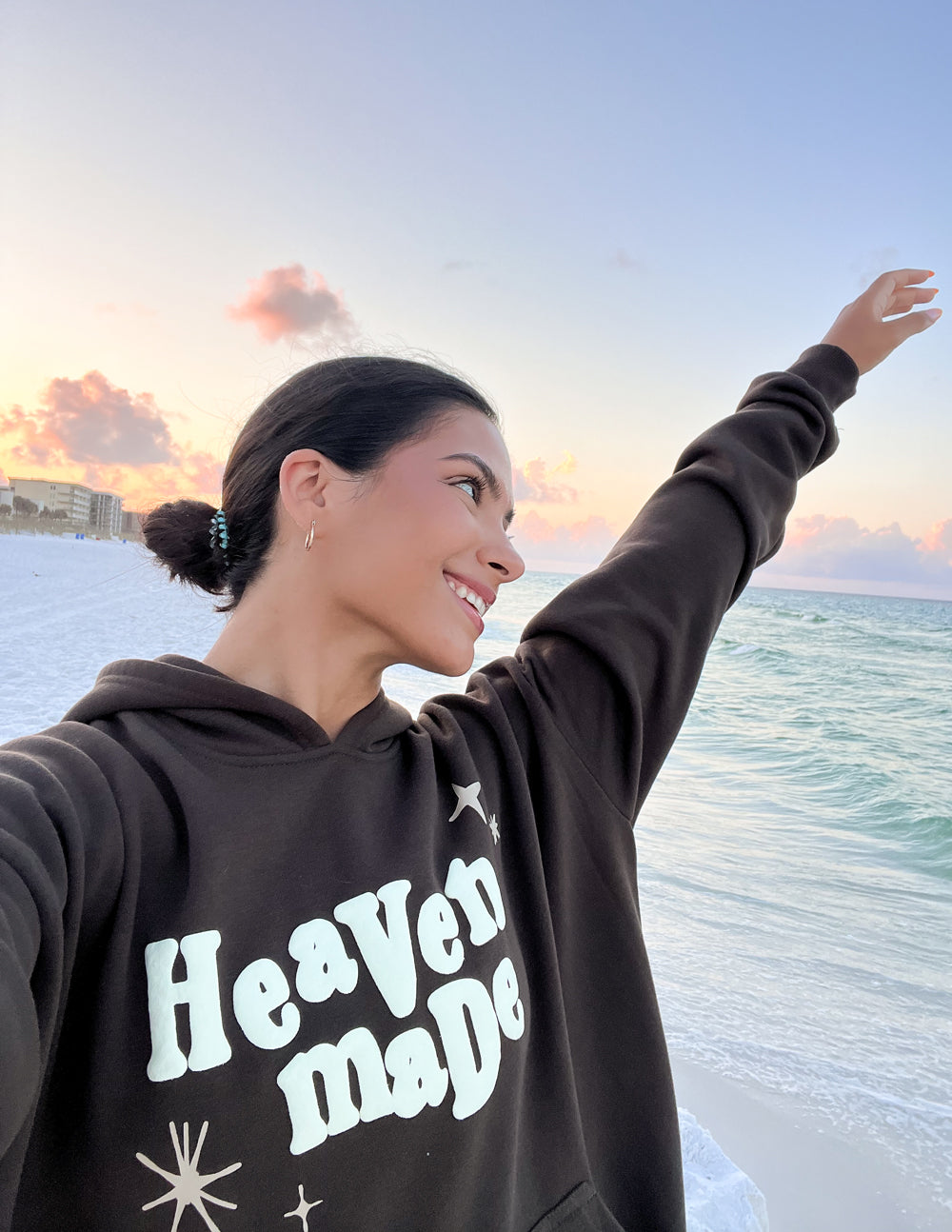 Dark brown unisex hoodie with hood and “Heaven Made” logo print on the chest.