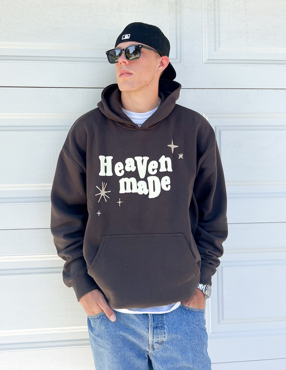 Unisex hoodie in dark brown with “Heaven Made” front logo and hood drawstrings.
